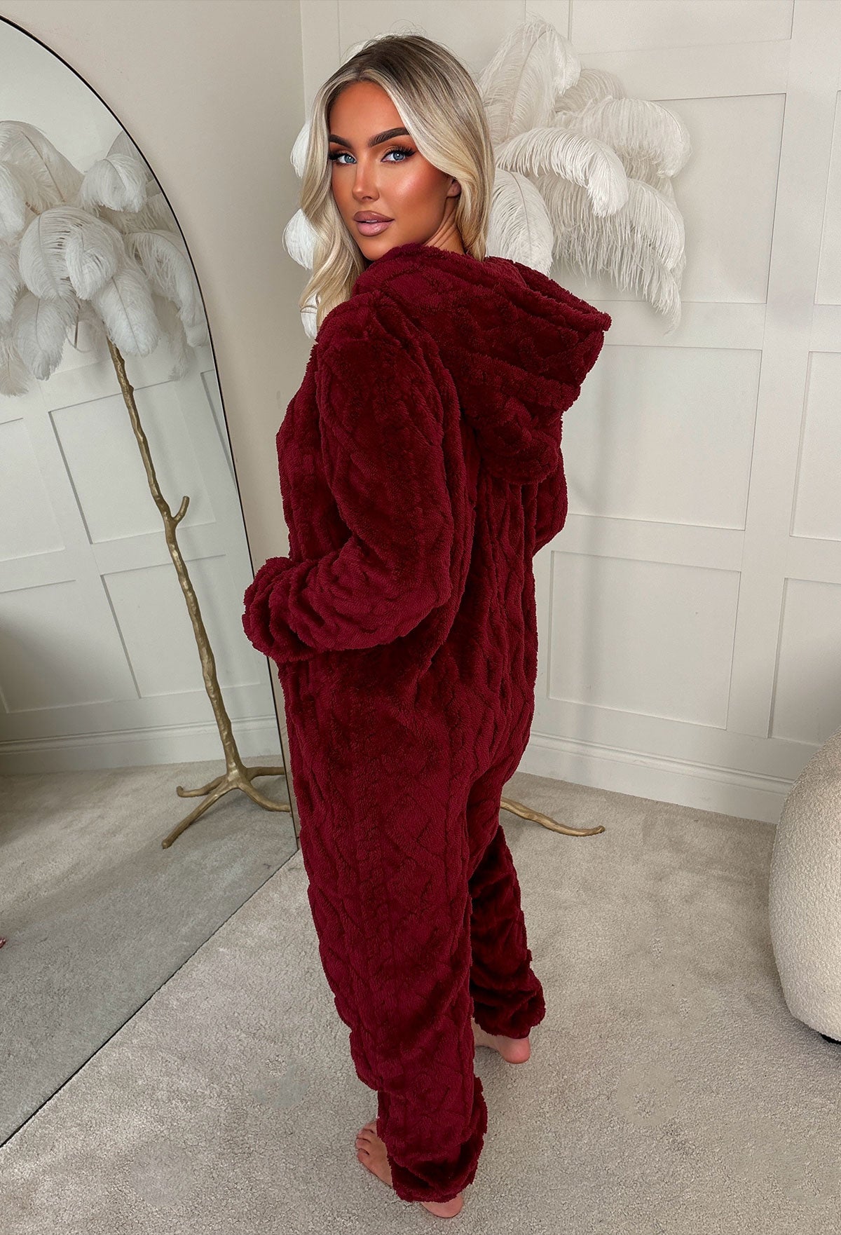 Burgundy cable knit fluffy onesie with long sleeves, cuffed hems and soft textured fabric.