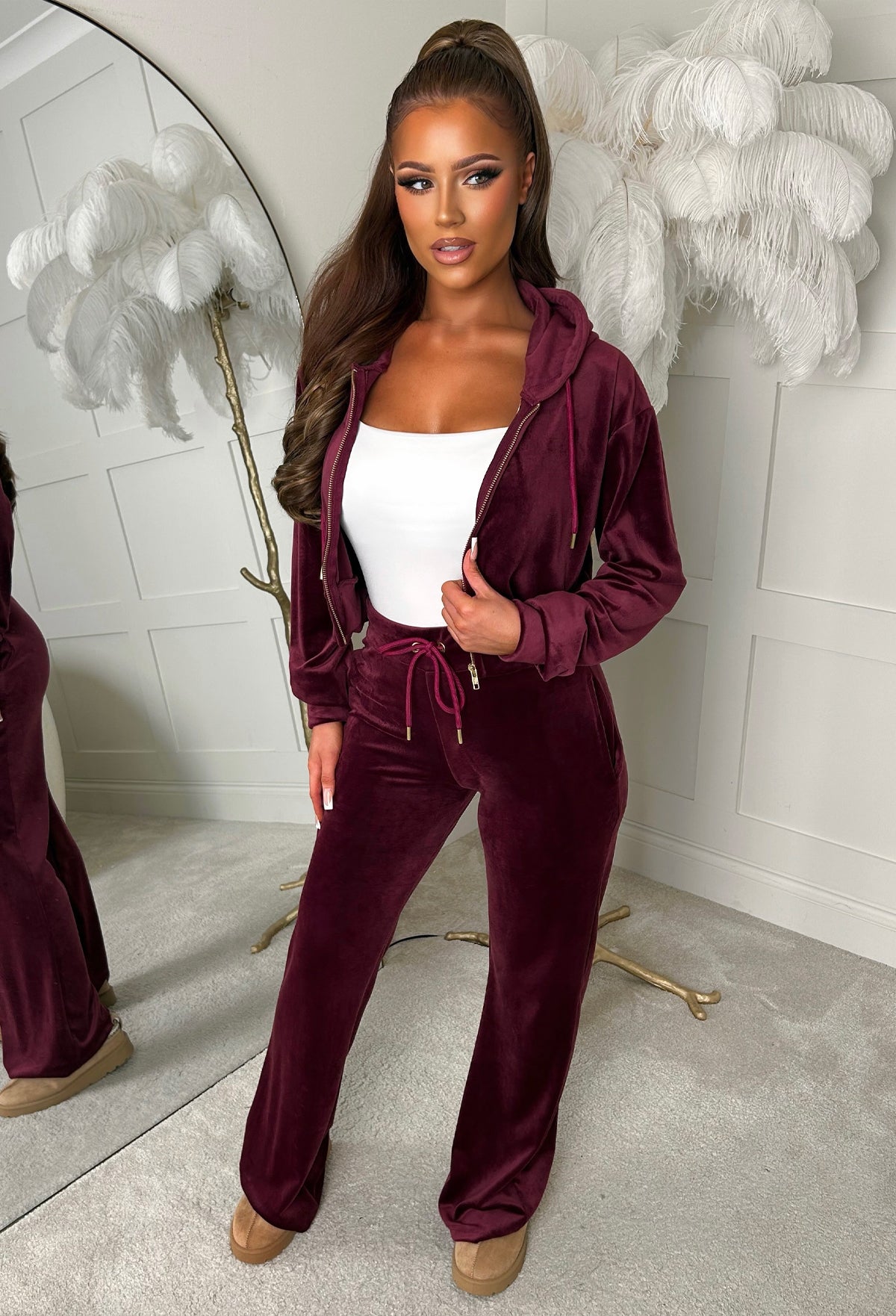 Burgundy velour tracksuit with a cropped zip-up hoodie, drawstring waist trousers and relaxed fit.