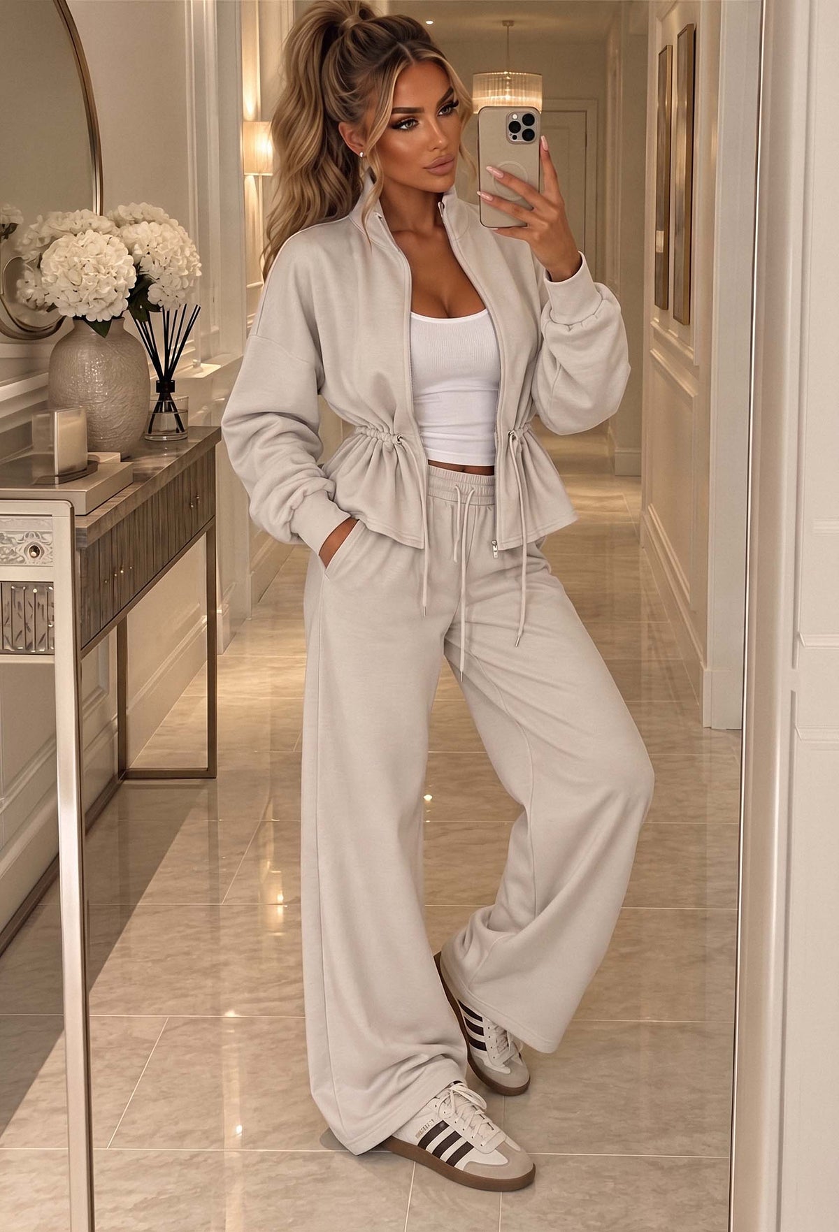 Cream drawstring waist co-ord set featuring a zip-up long sleeve top and wide leg trousers.