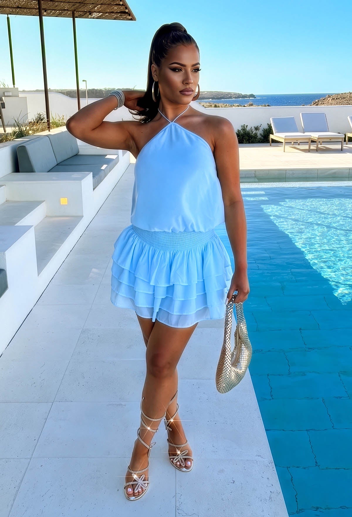 Model By Pool Wearing Blue Frill Halter Mini Dress Full Length Front View