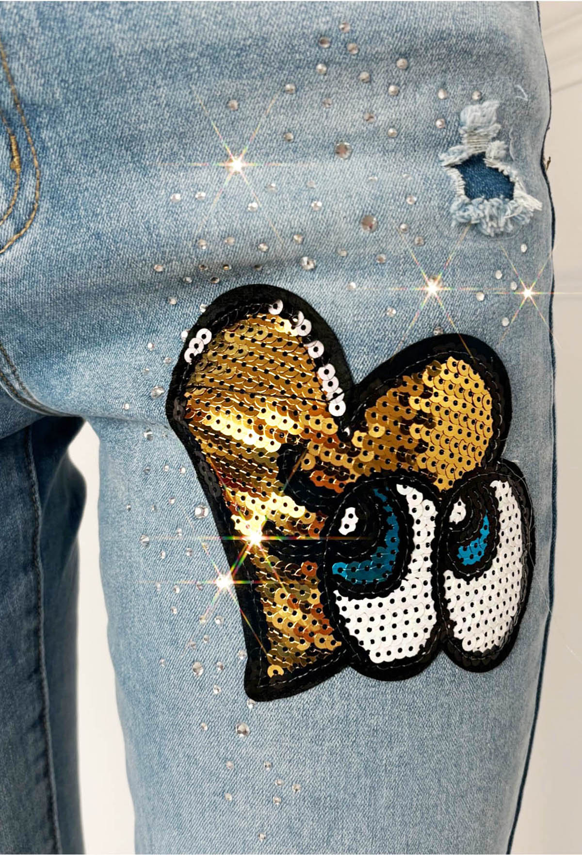 Mid wash denim jeans with slim straight leg fit, distressed details and sequin heart graffiti patches.