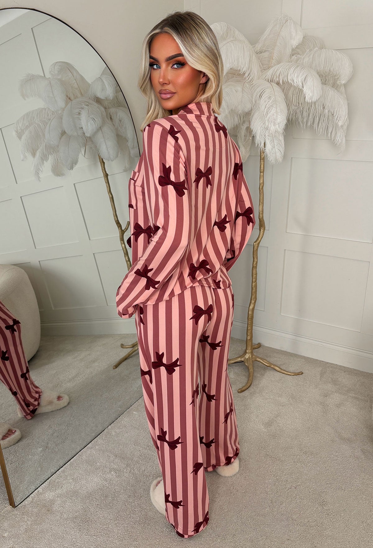 Burgundy bow print pyjama set with a long sleeve button-up shirt, chest pocket and wide leg trousers.