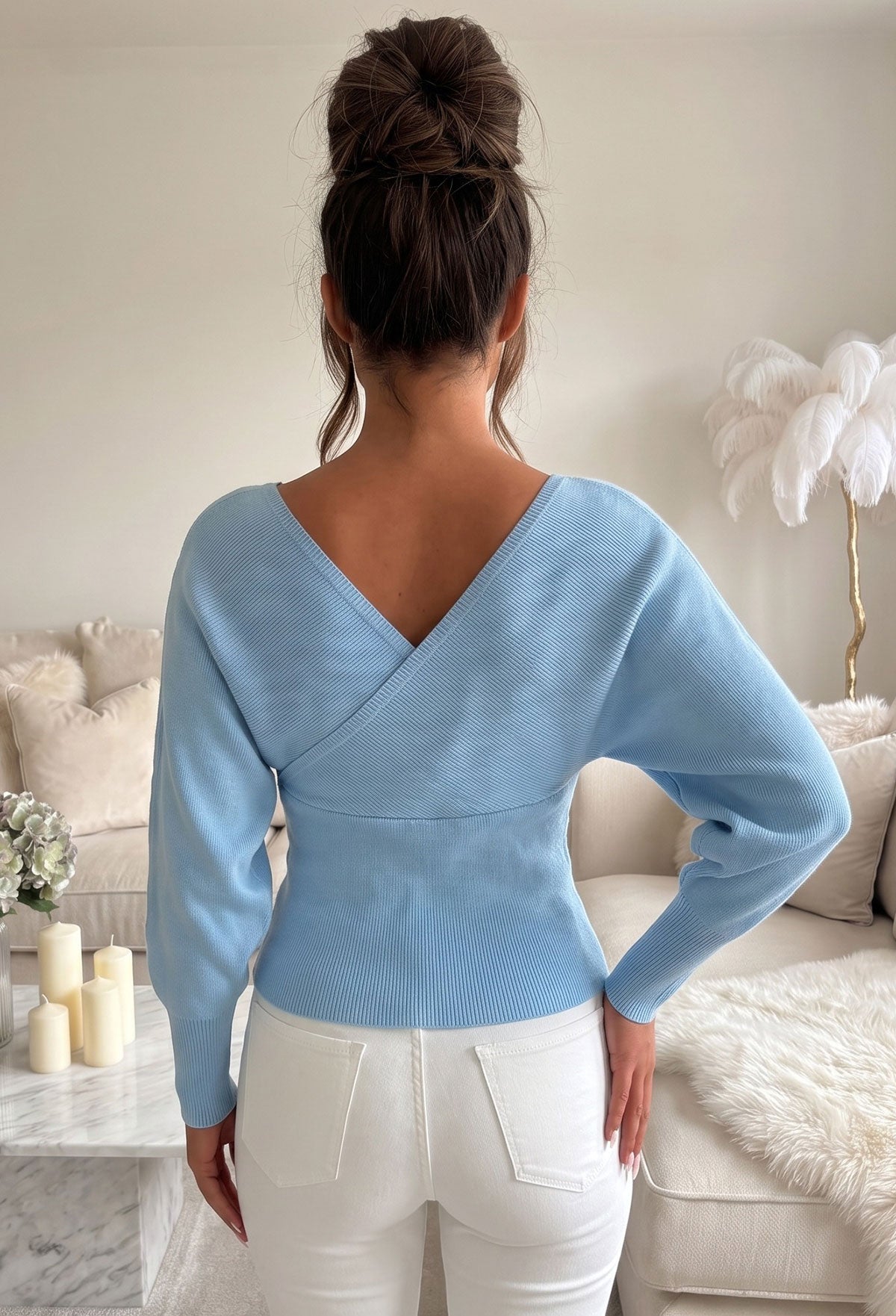Blue wrap over v neck jumper with long batwing sleeves and a fitted ribbed waist.