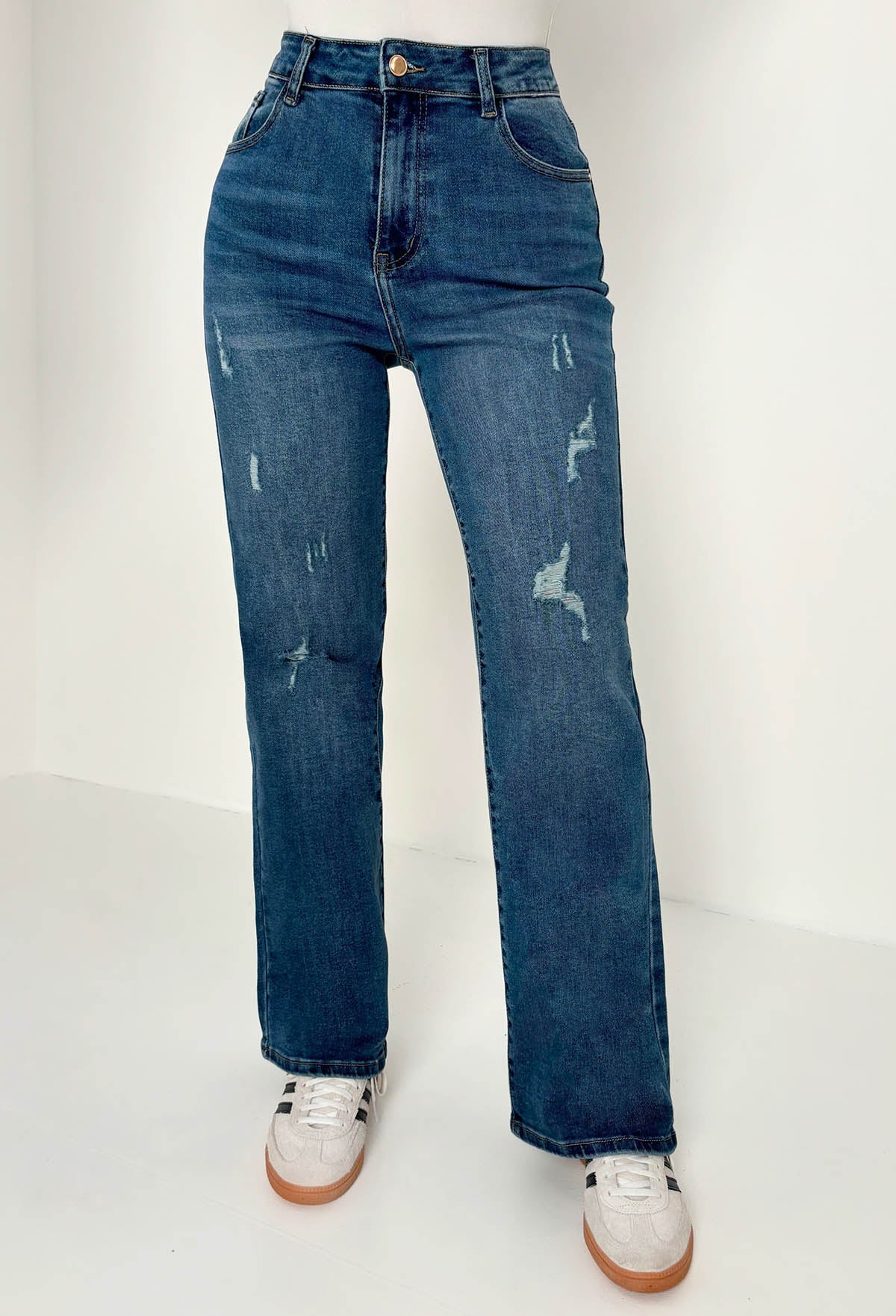 Back view of mid wash straight leg jeans with a high waist, classic five-pocket design and subtle fading.