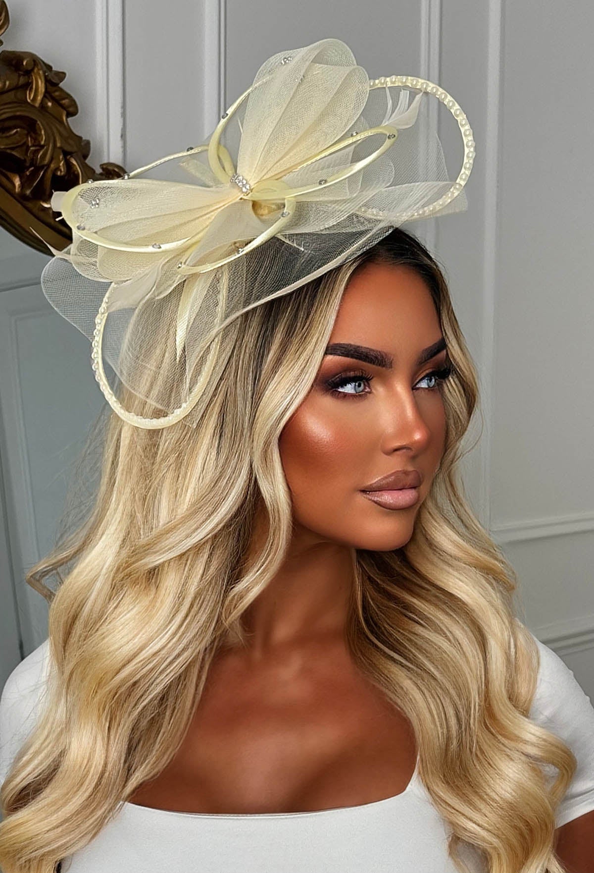 Butter yellow diamante veil fascinator featuring layered mesh loops, sparkling diamante accents and a delicate net veil.