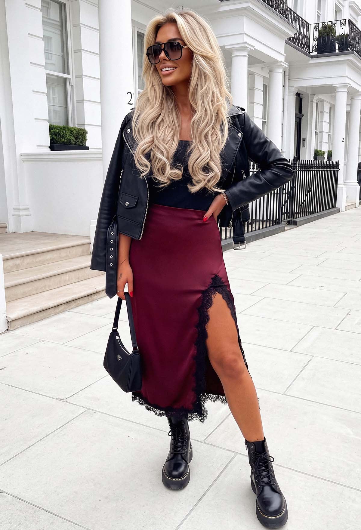Plum satin lace trim side slit midi skirt with black lace edging, styled with a black crop top and boots.