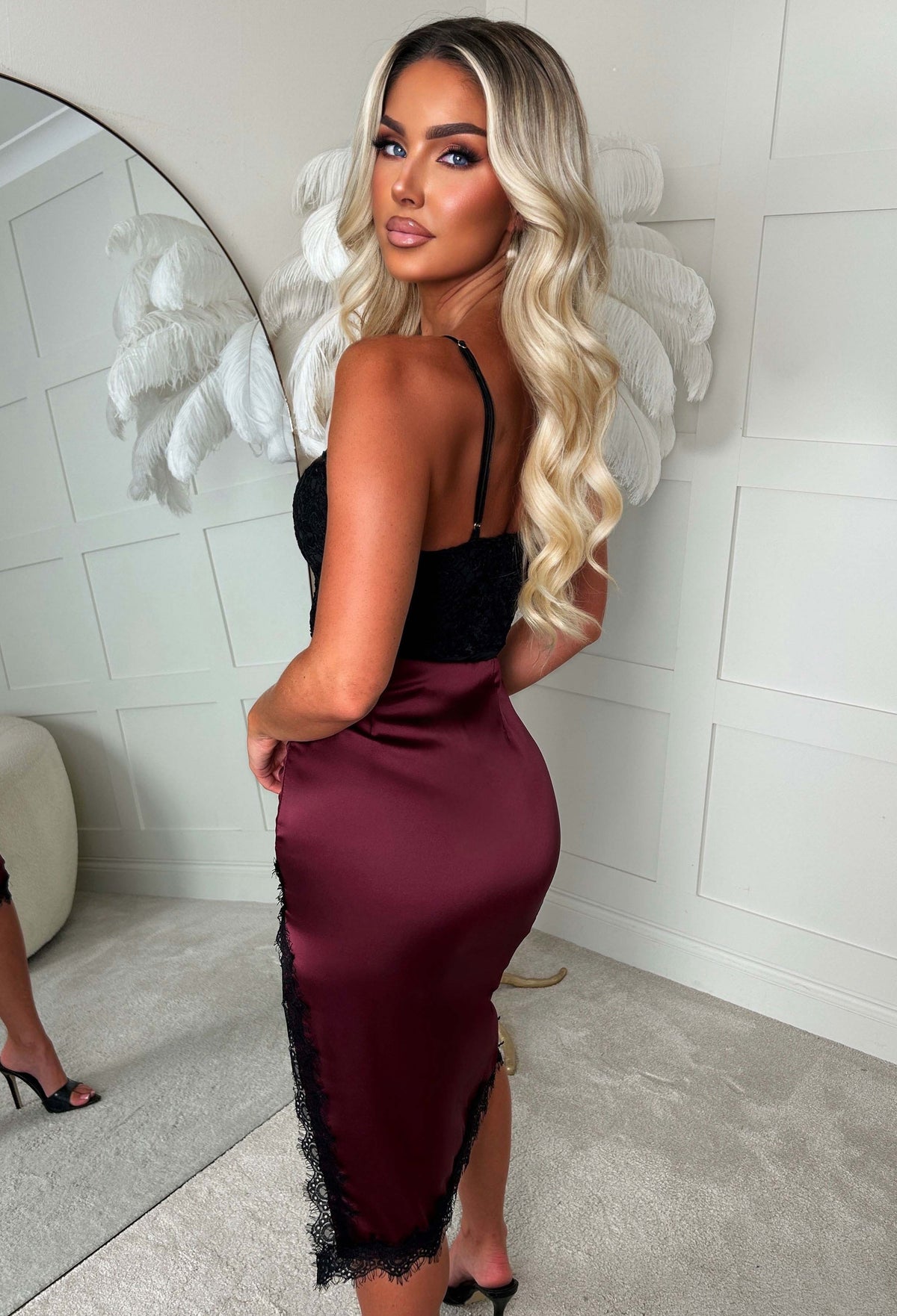 Plum satin lace trim side slit midi skirt with black lace edging, styled with a black crop top and boots.