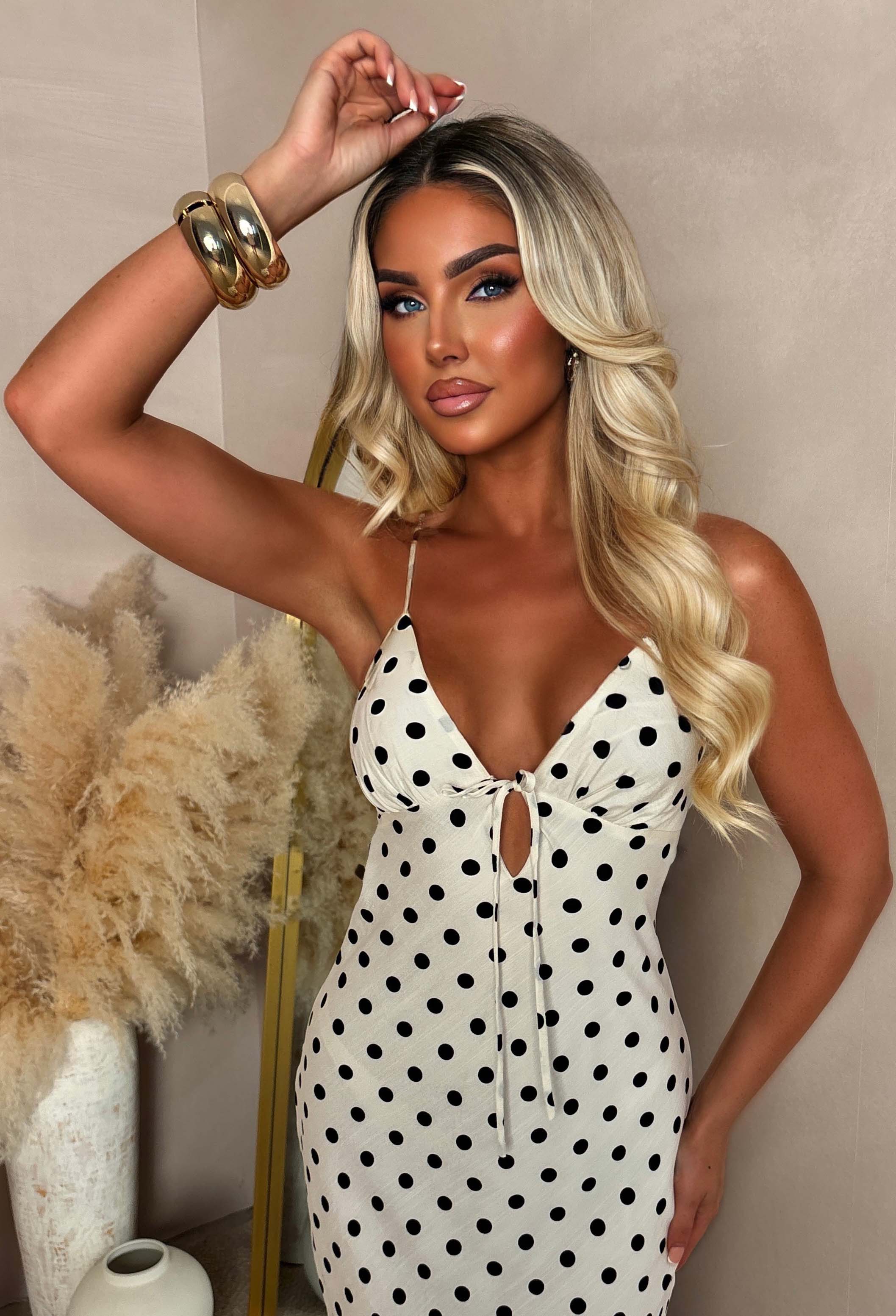 Neutral polka dot cut out back maxi dress with a fitted silhouette and thin straps.