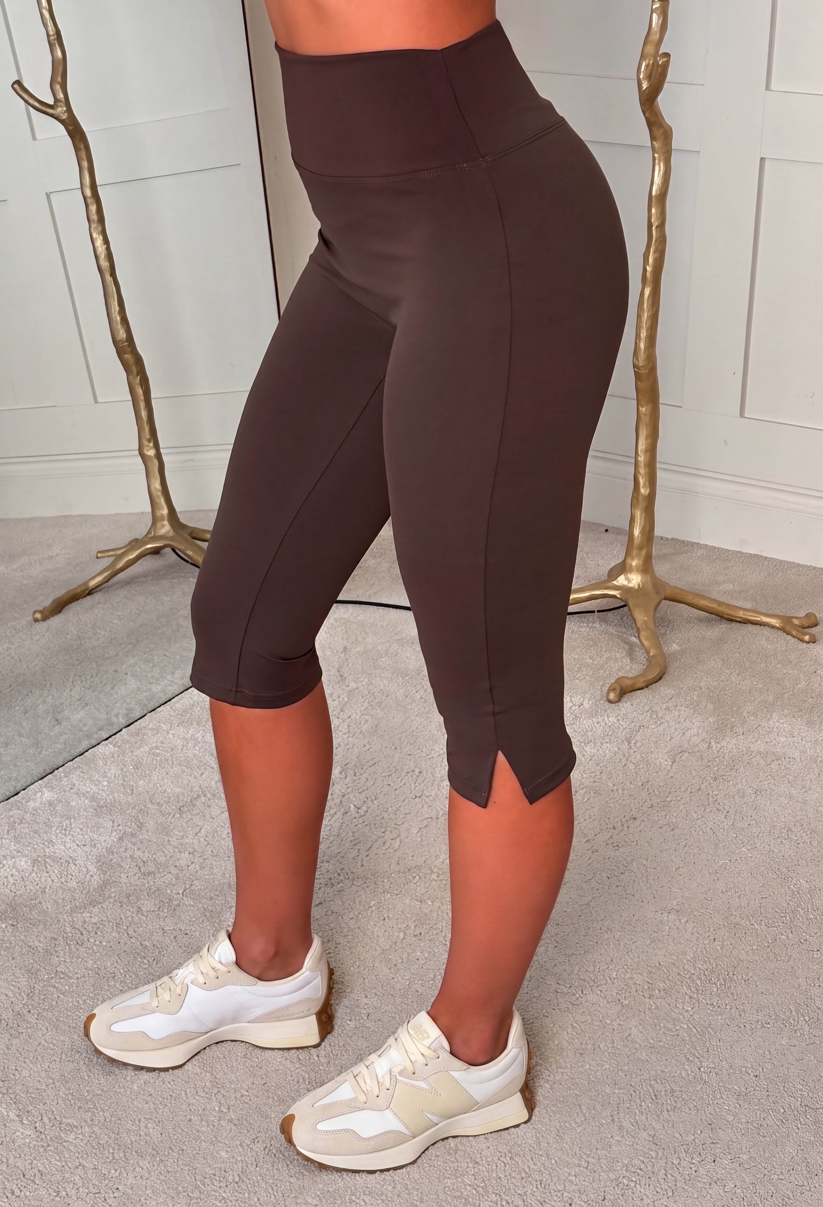 Mocha brown capri activewear leggings with a high waist, cropped peddlepusher length and smooth stretch fabric.