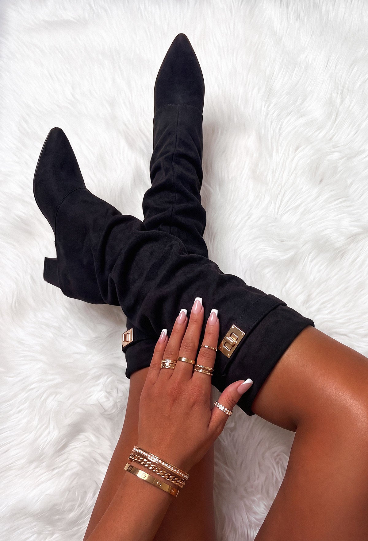 Black faux suede fold over maxi lock shark boot with pointed toe, slouchy shaft and gold lock detail.