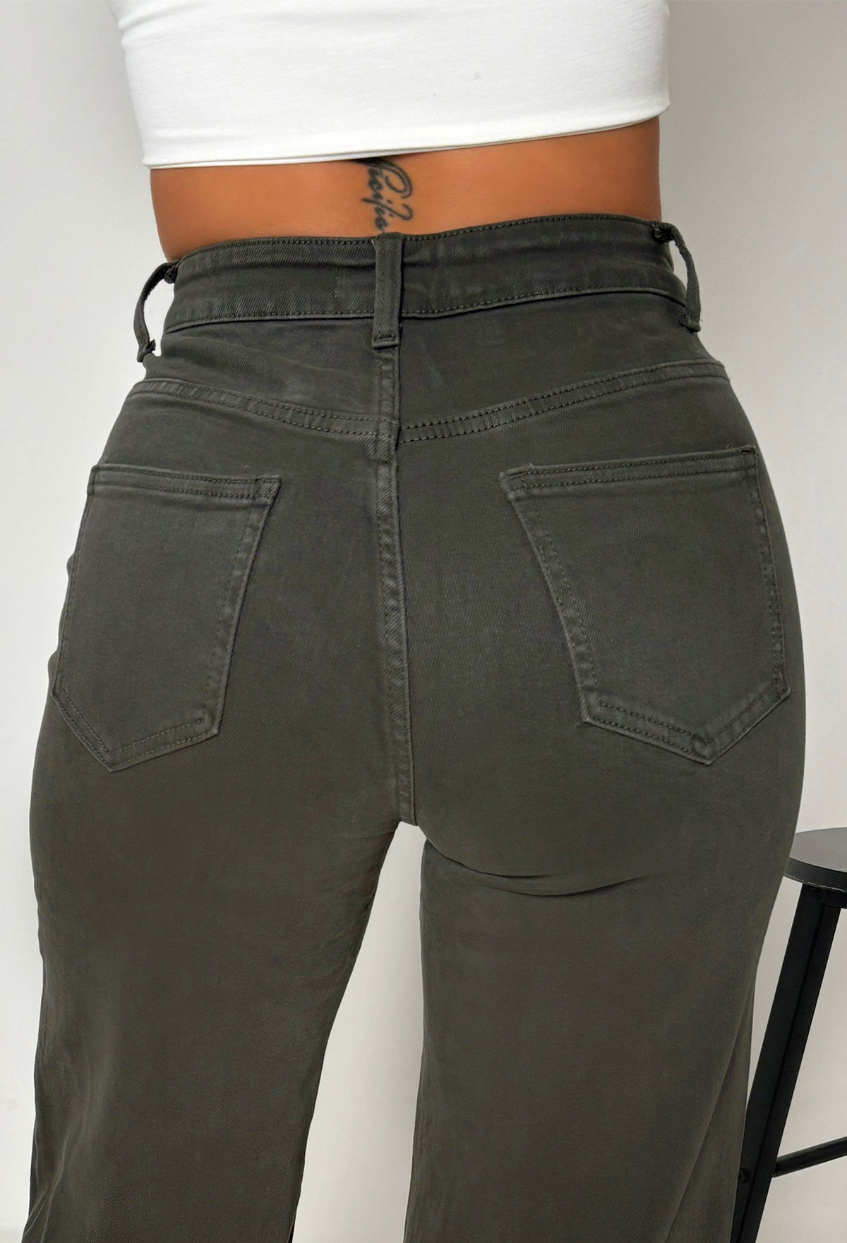 Khaki stretch wide leg jean with high waist, belt loops, full-length hem and a beige belt.