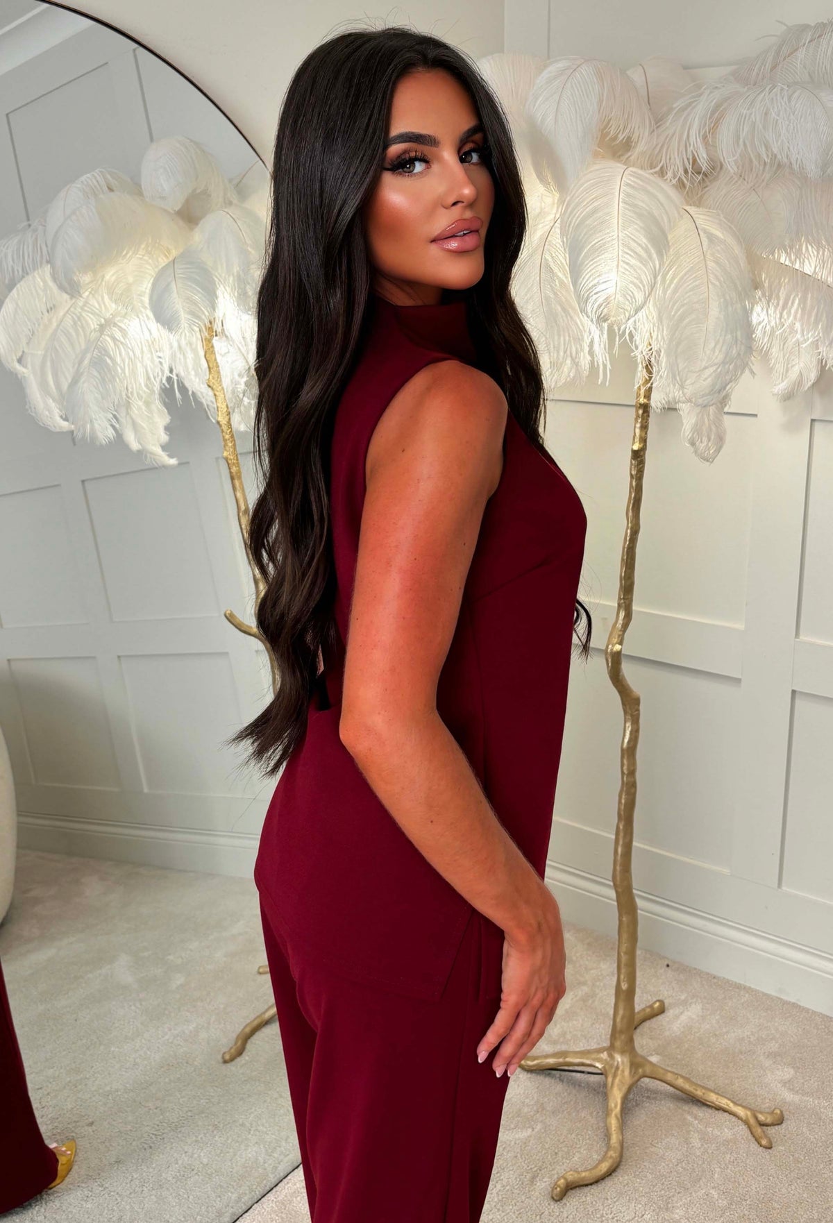 Burgundy high neck ruched top with a fitted sleeveless shape and smooth finish, styled as a co-ord.