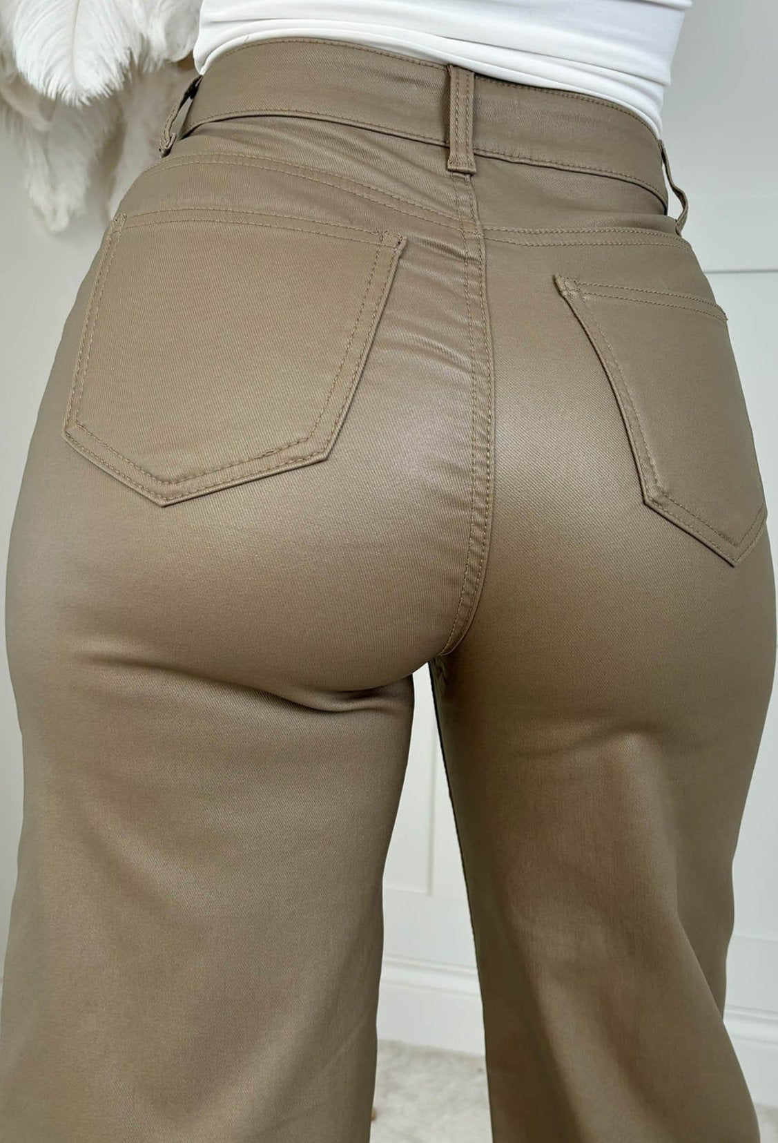 Neutral faux leather stretch wide leg jeans with a high waist, classic five-pocket design and full-length hem.