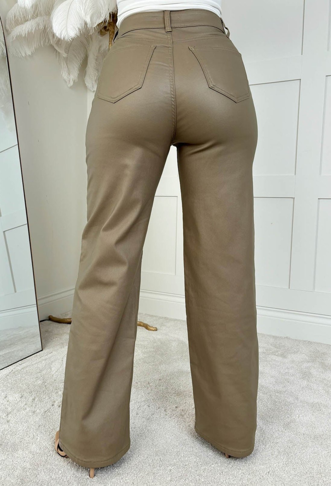 Neutral faux leather stretch wide leg jeans with a high waist, classic five-pocket design and full-length hem.