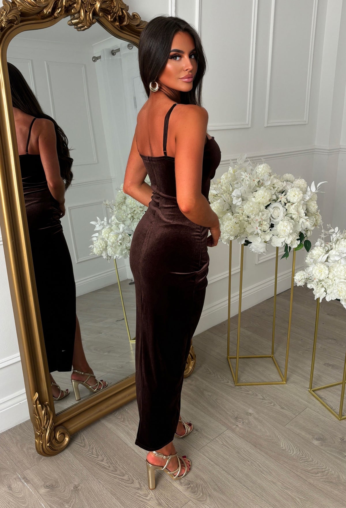 Chocolate brown velvet midi dress with a notch neck, ruched detailing, thin straps and an asymmetric hem.
