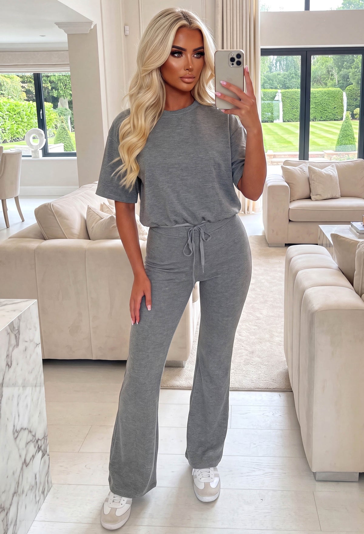 Taupe lounge co-ord set with a bubble hem short sleeve top and matching flared leg trousers with drawstring waist.