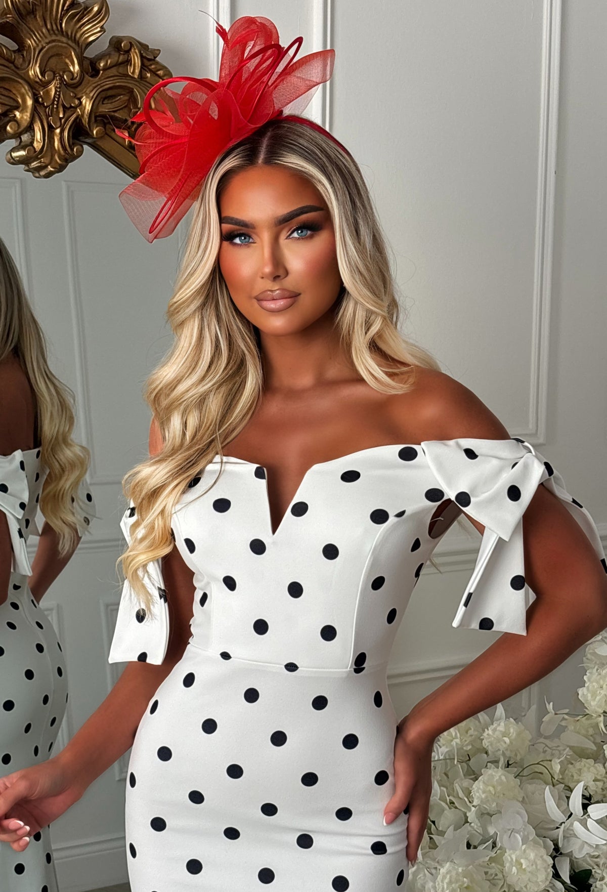 Monochrome polka dot midaxi dress with off-the-shoulder neckline, fitted silhouette and side bow detail.