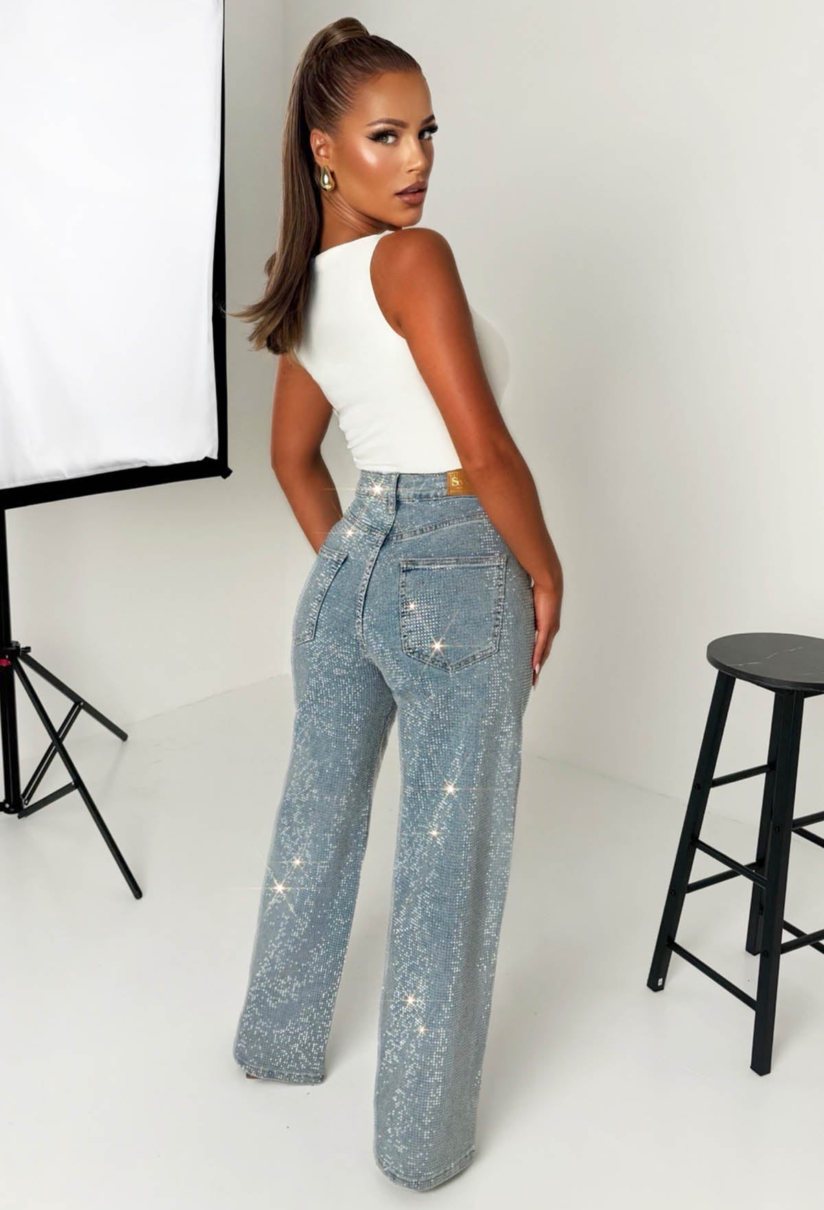 Mid wash straight leg stretch diamante jeans with all-over sparkling embellishments and classic five-pocket design.