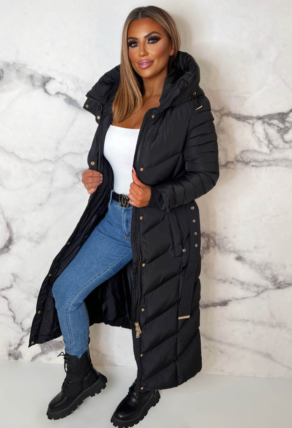 Black chevron belted hooded padded coat with fleece lining, gold hardware and long quilted sleeves.