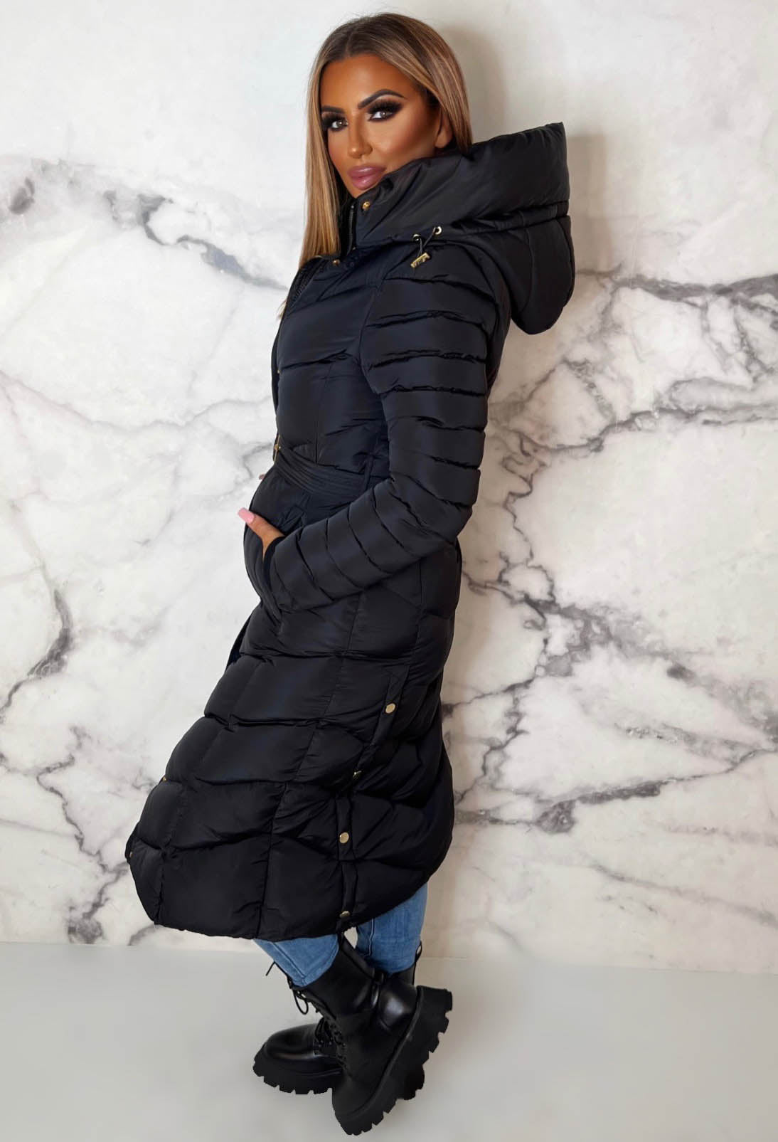 Black chevron belted hooded padded coat with fleece lining, gold hardware and long quilted sleeves.