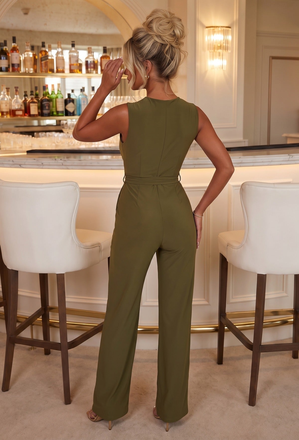 Khaki cross front belted jumpsuit with a plunging neckline, sleeveless design and wide leg fit in stretchy fabric.