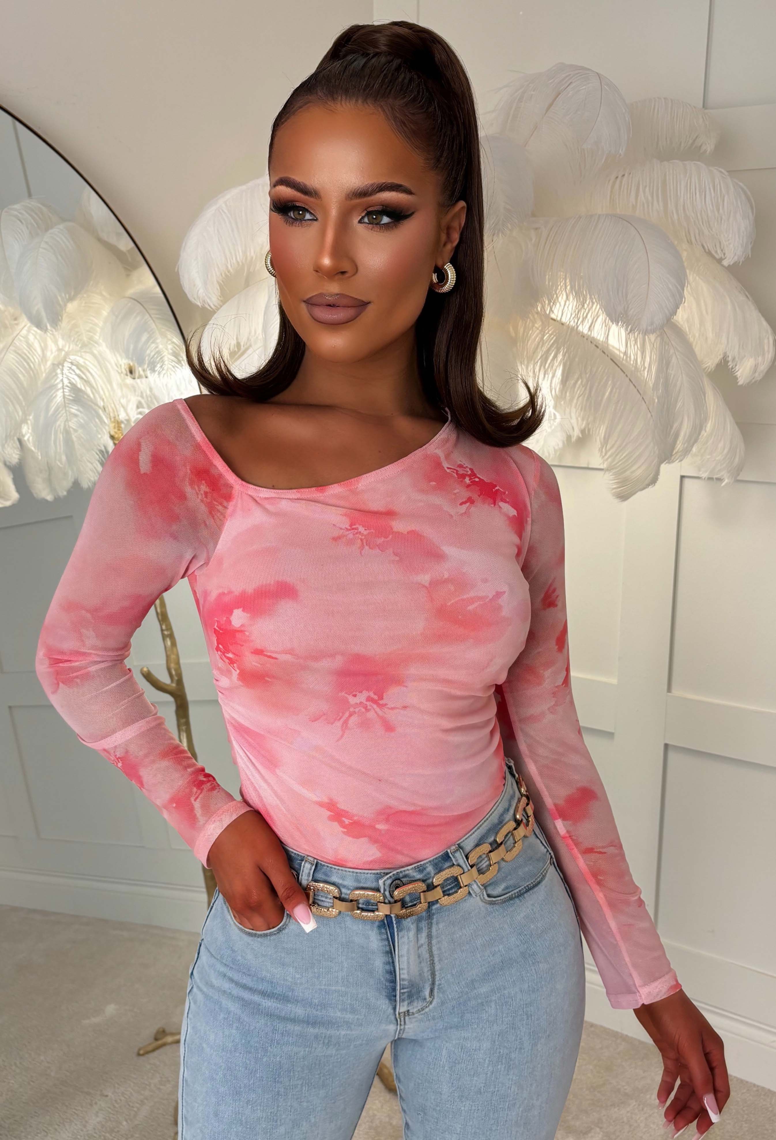 close up shot Pink marble print off-shoulder mesh top with a bardot neckline, ruched side detailing, and a fitted silhouette for a bold, statement look.