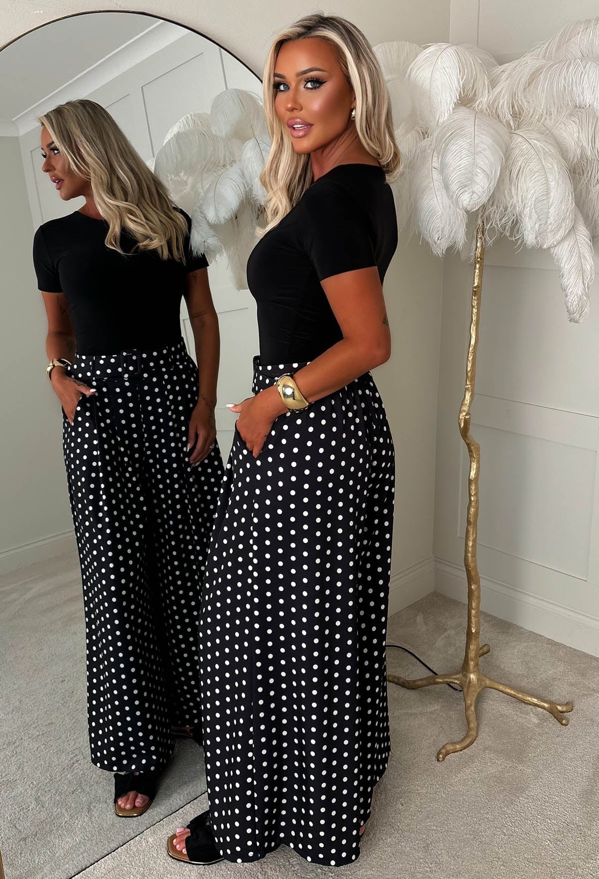 Black polka dot wide leg belted trousers with high waist, detachable belt and relaxed, flowing fit.