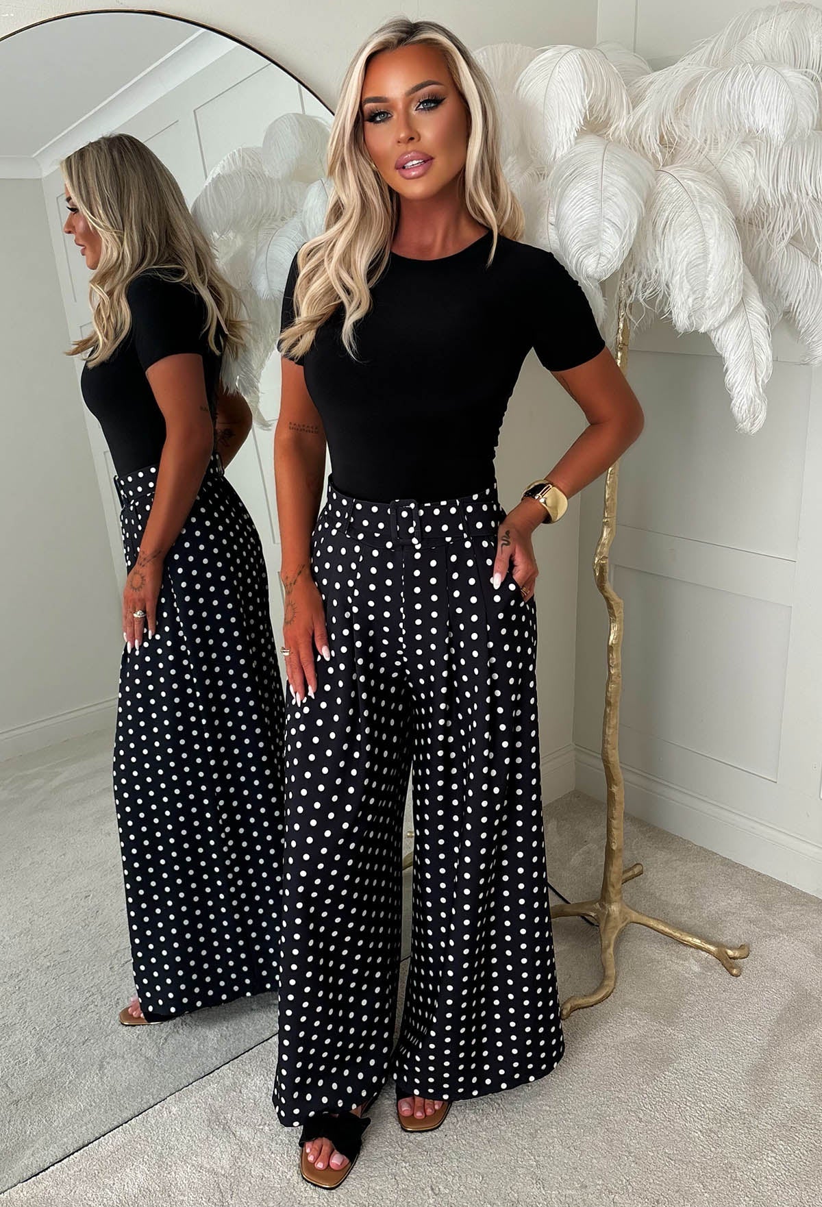 Black polka dot wide leg belted trousers with high waist, detachable belt and relaxed, flowing fit.