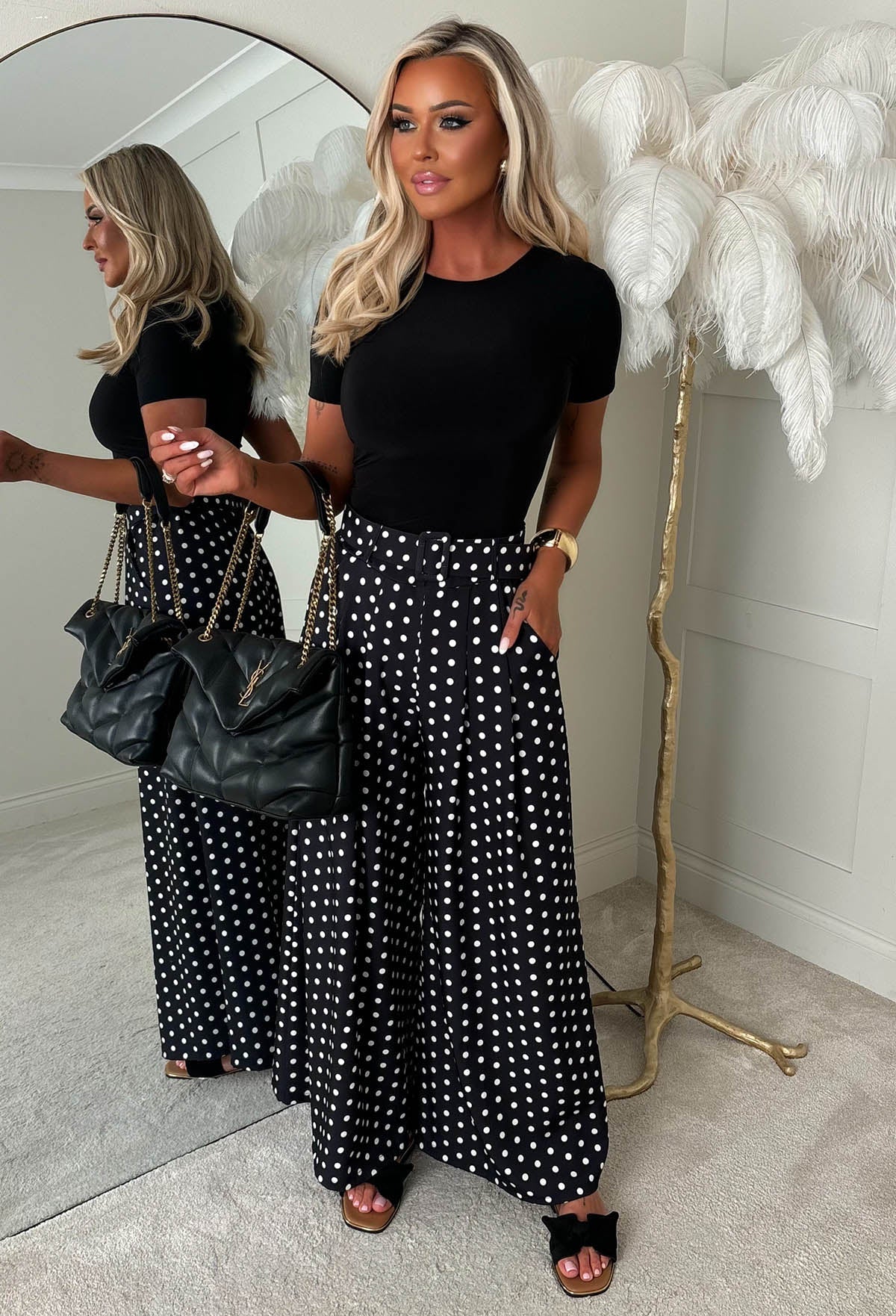Black polka dot wide leg belted trousers with high waist, detachable belt and relaxed, flowing fit.