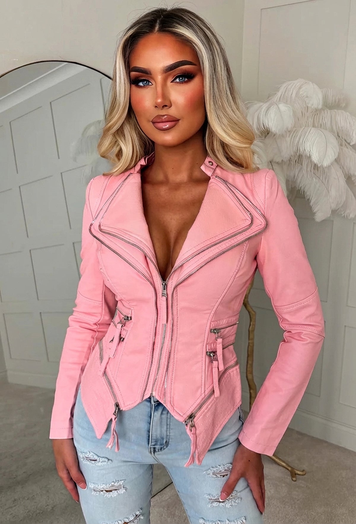 Pink fitted faux leather biker jacket with asymmetric zip fastening, notched collar and zip pocket details.