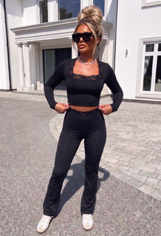 Black long sleeve lace trim lounge co-ord with a cropped top and matching high-waisted flared trousers.