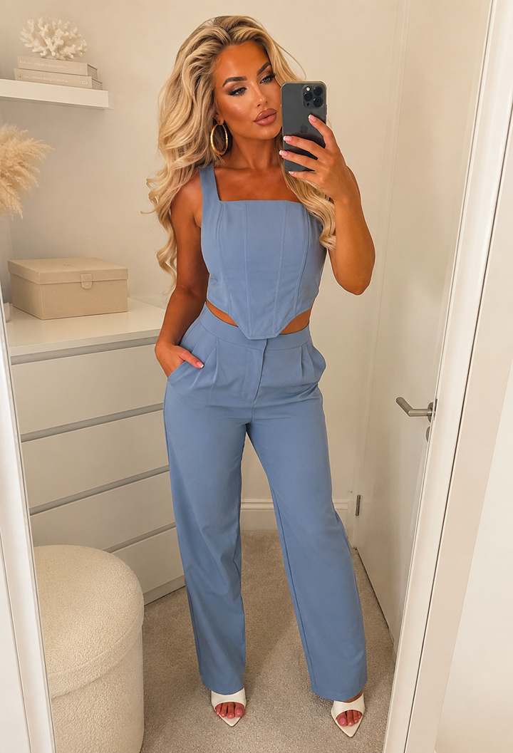 Blue corset top and trouser two piece with wide straps, square neckline and fitted high-waisted trousers.