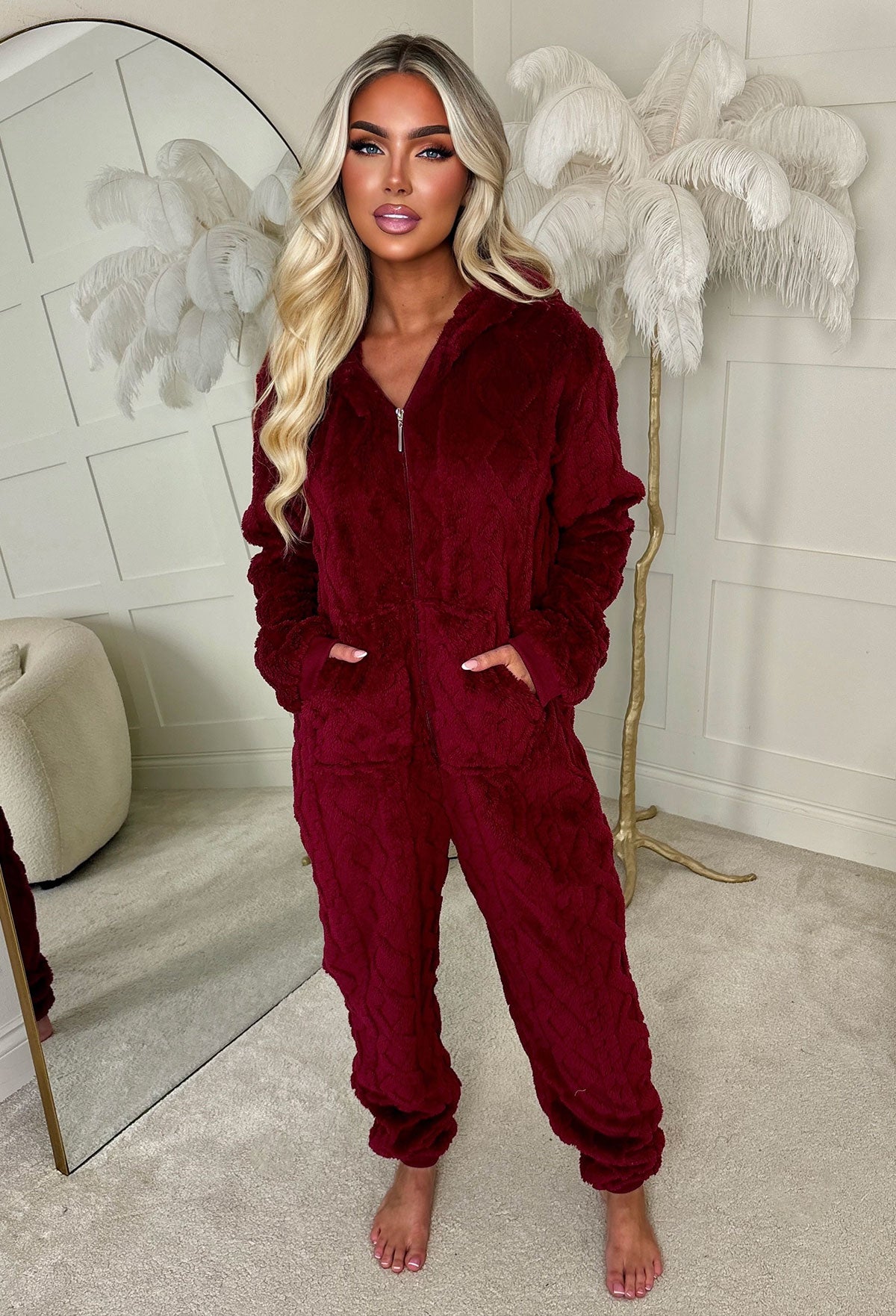 Burgundy cable knit fluffy onesie with long sleeves, cuffed hems and soft textured fabric.