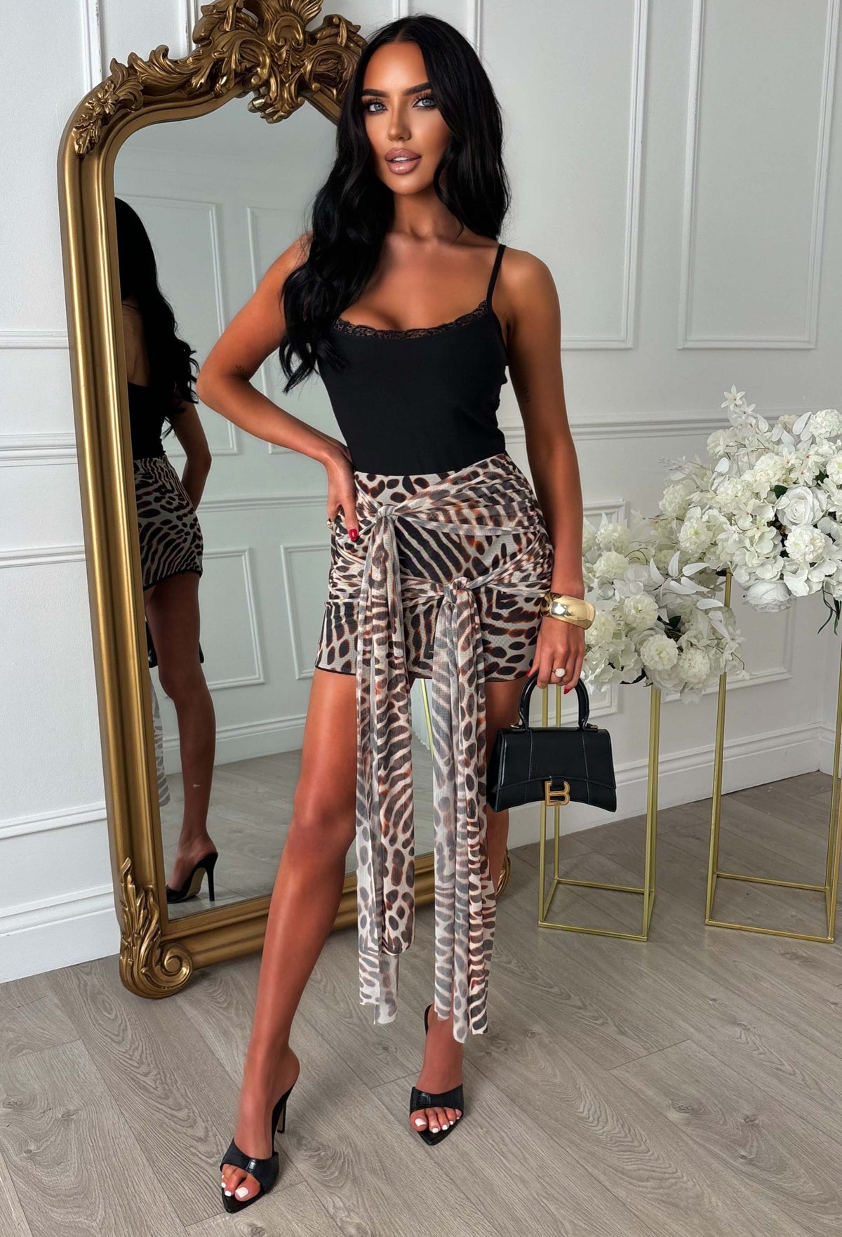 Brown animal print mesh mini skirt with double wrap tie front, ruched detailing and a short hemline.