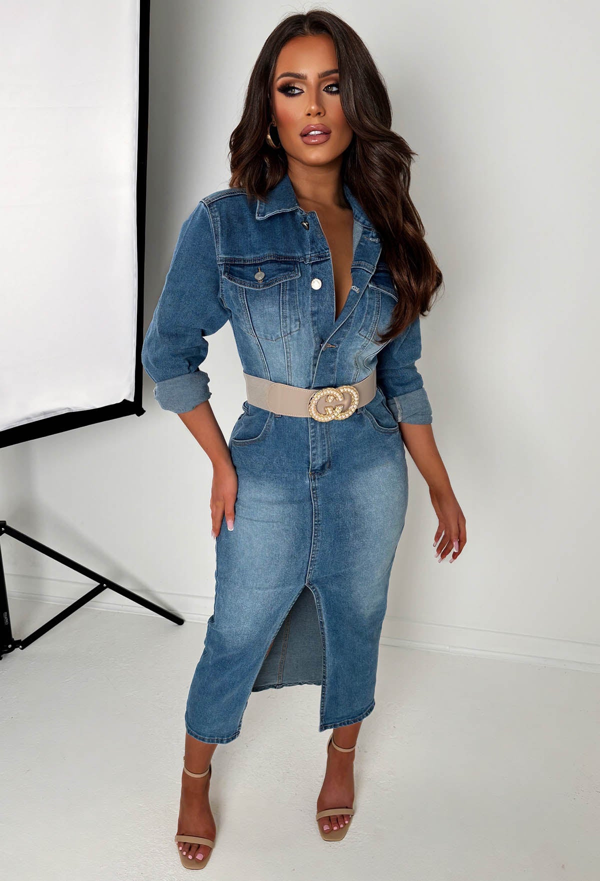 Mid wash stretch denim long sleeve dress with button front, chest pockets and a front split hem.