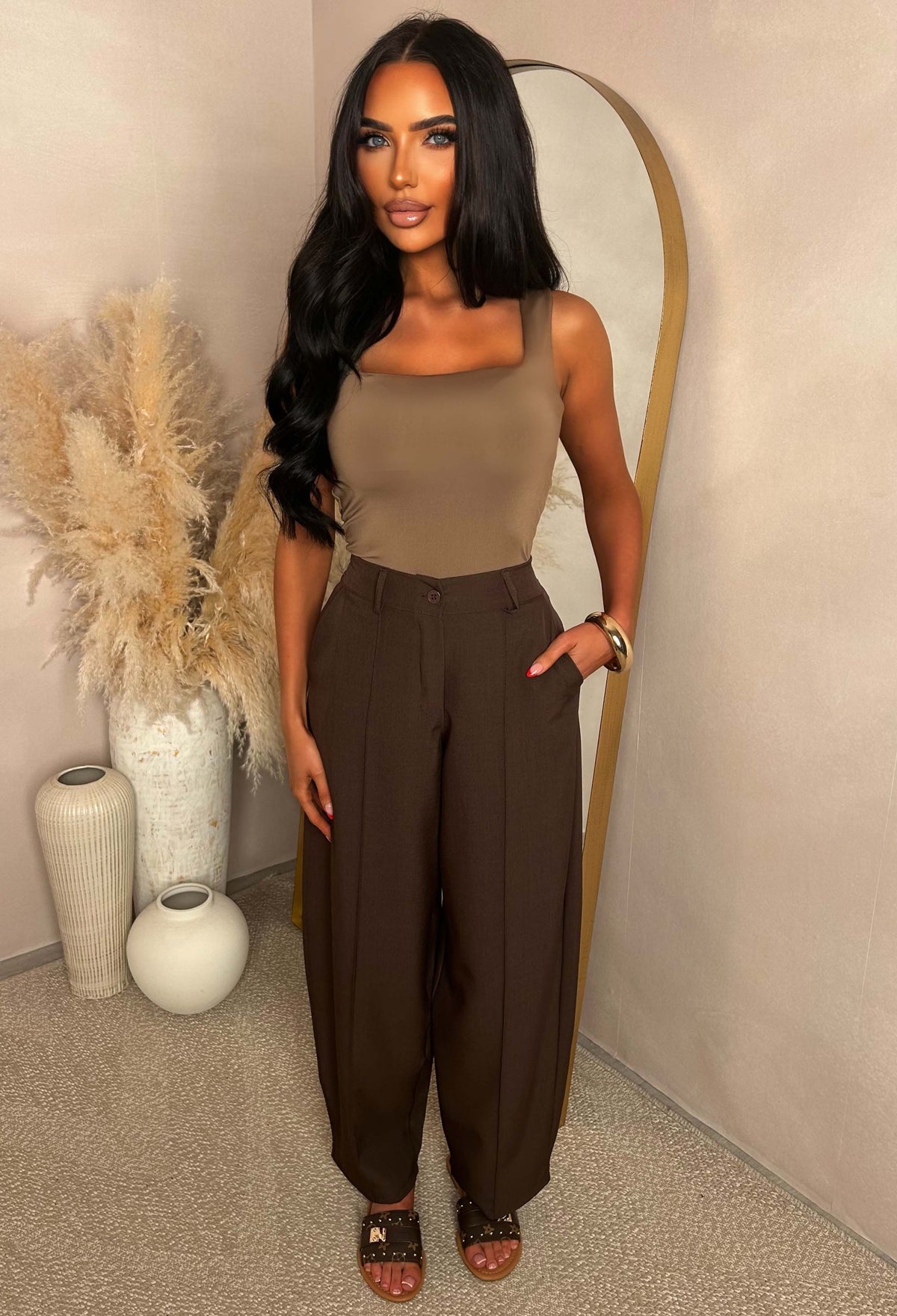Brown barrel fit trousers with a high elasticated waistband, front seam detail and styled with sandals.