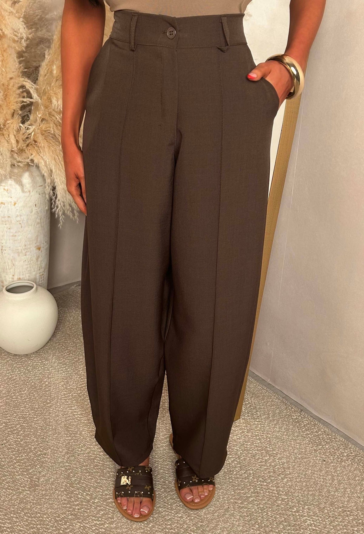 Brown barrel fit trousers with a high elasticated waistband, front seam detail and styled with sandals.