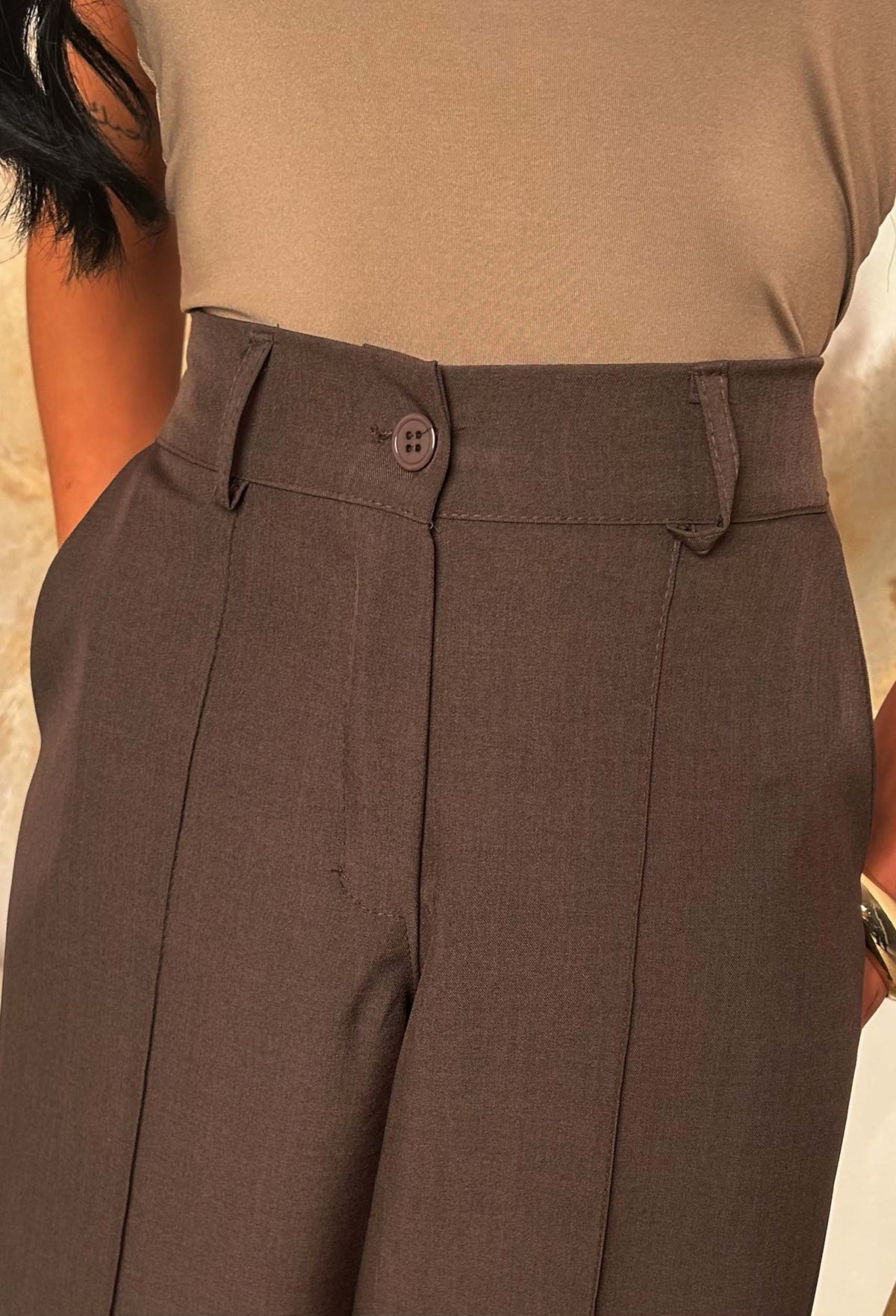 Brown barrel fit trousers with a high elasticated waistband, front seam detail and styled with sandals.