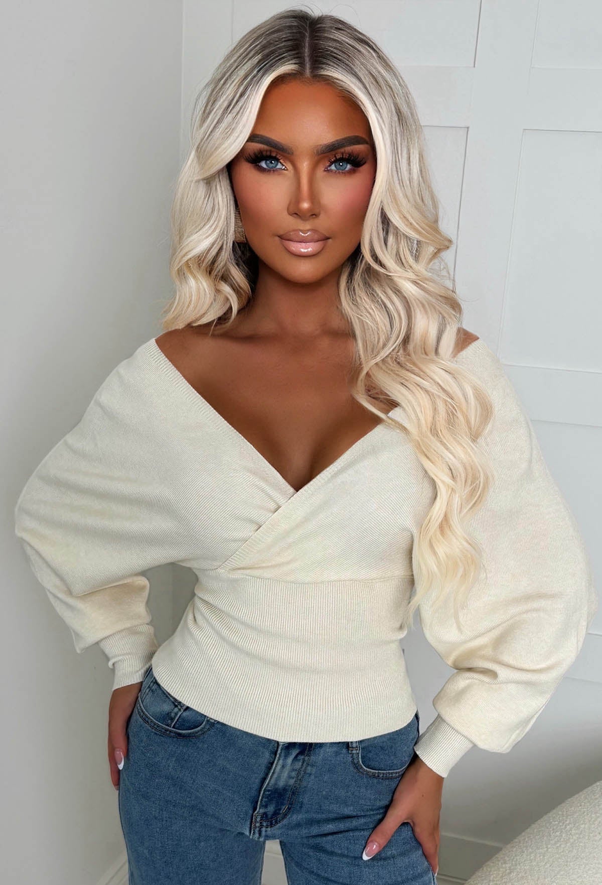 Cream wrap over V neck jumper with long batwing sleeves and a fitted ribbed waist.