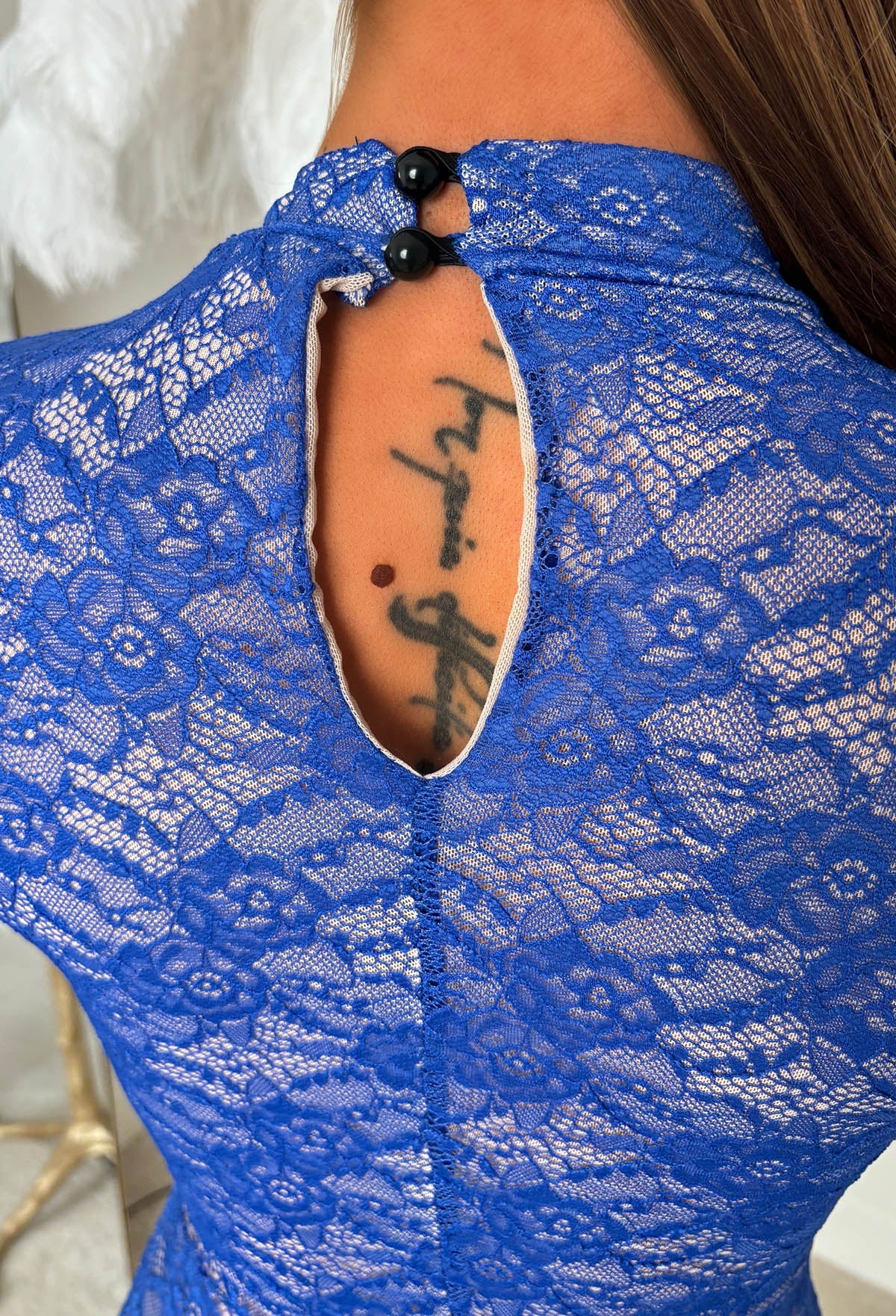 Cobalt blue lace bodysuit with long sleeves, scalloped keyhole neckline and fitted silhouette.