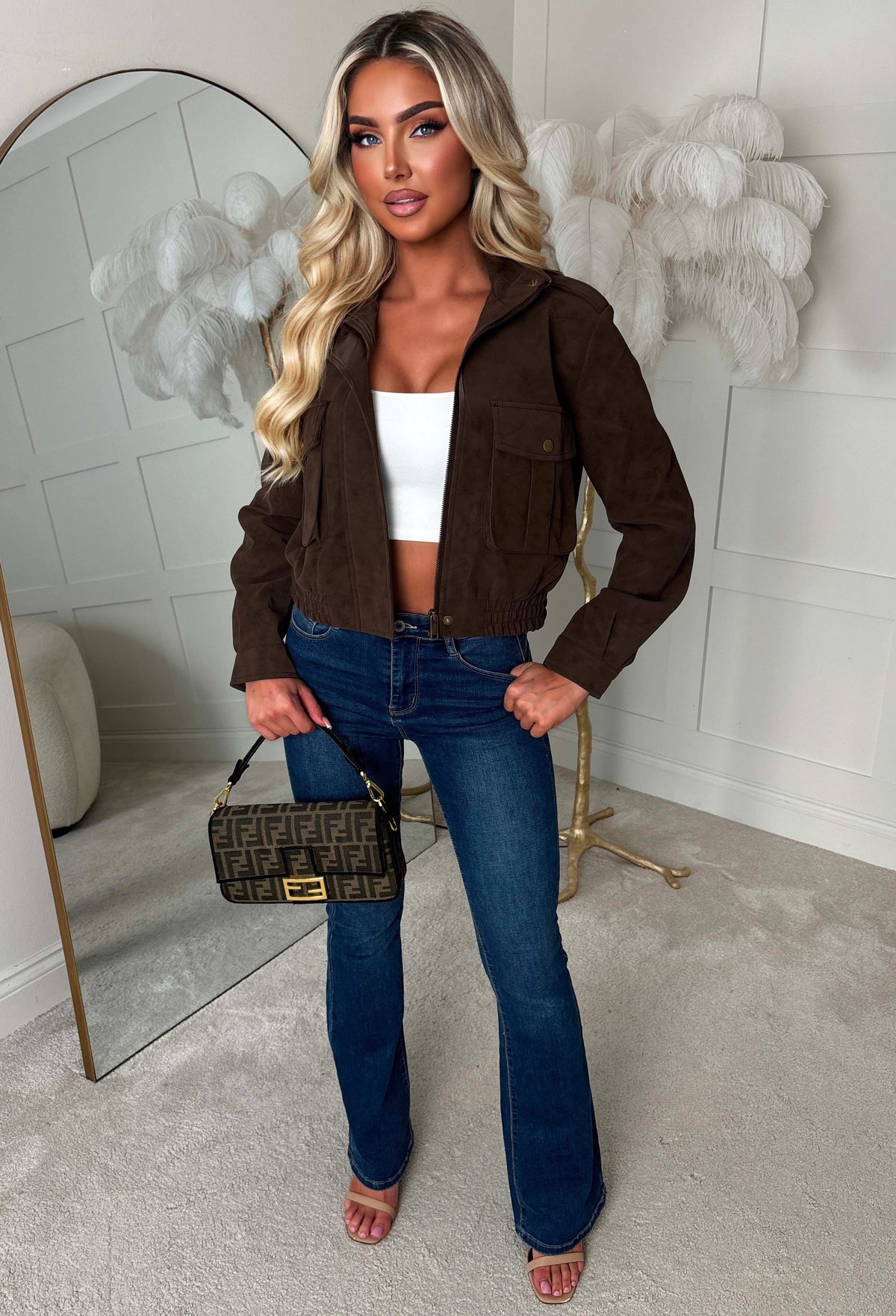 Chocolate brown faux leather bomber jacket with front zip, flap pockets and a cropped fit.