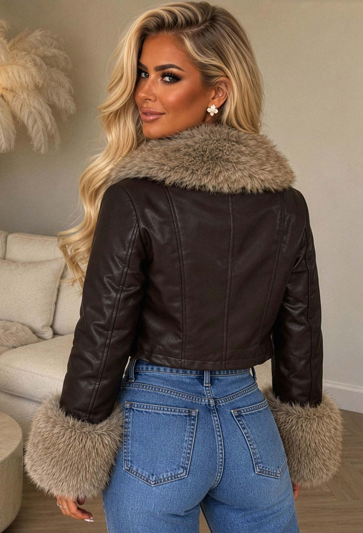 Chocolate brown faux fur leather jacket with eyelet lace-up detail, zip fastening, and fluffy collar and cuffs.