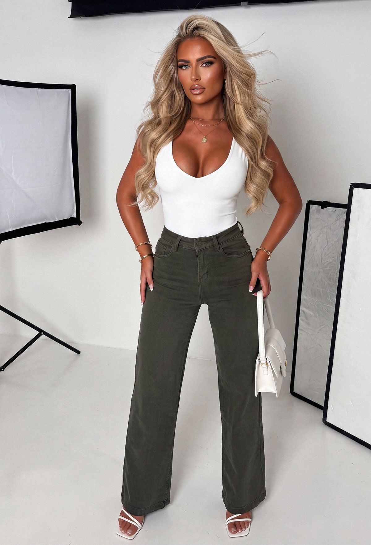 Khaki stretch wide leg jean with high waist, belt loops, full-length hem and a beige belt.