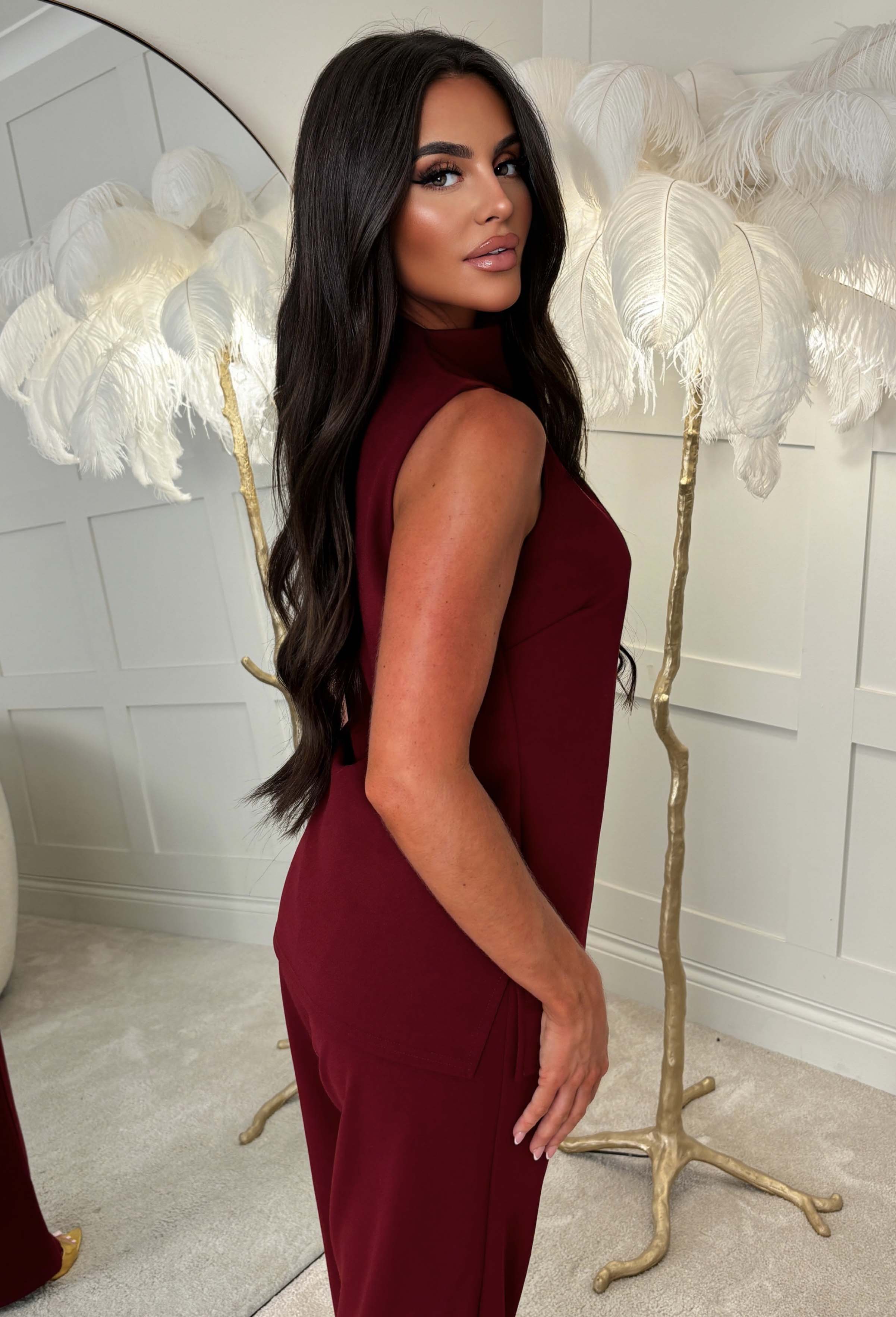 Burgundy high neck ruched top with a fitted sleeveless shape and smooth finish, styled as a co-ord.