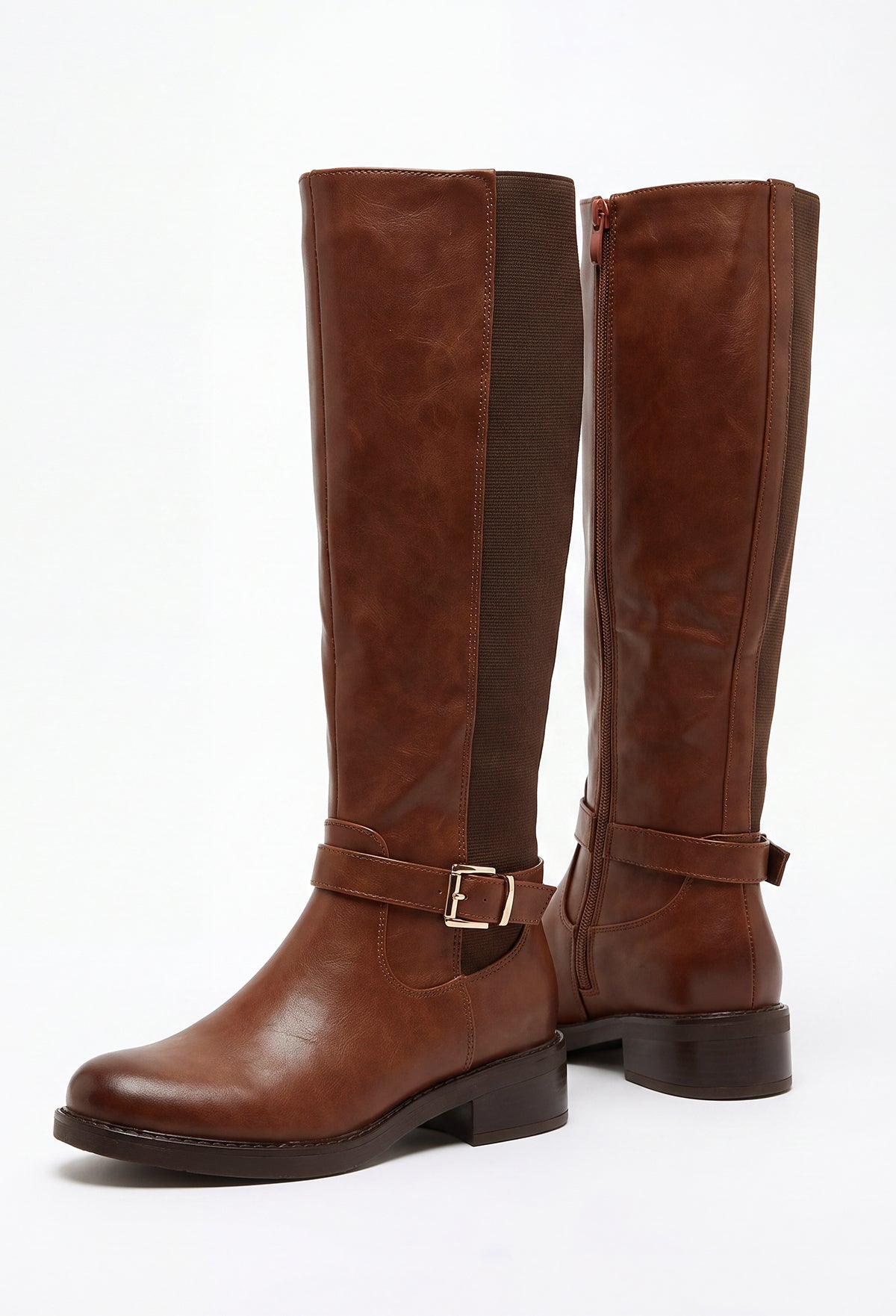 Brown faux leather riding boot with gold buckle trim, knee-high length and low block heel.