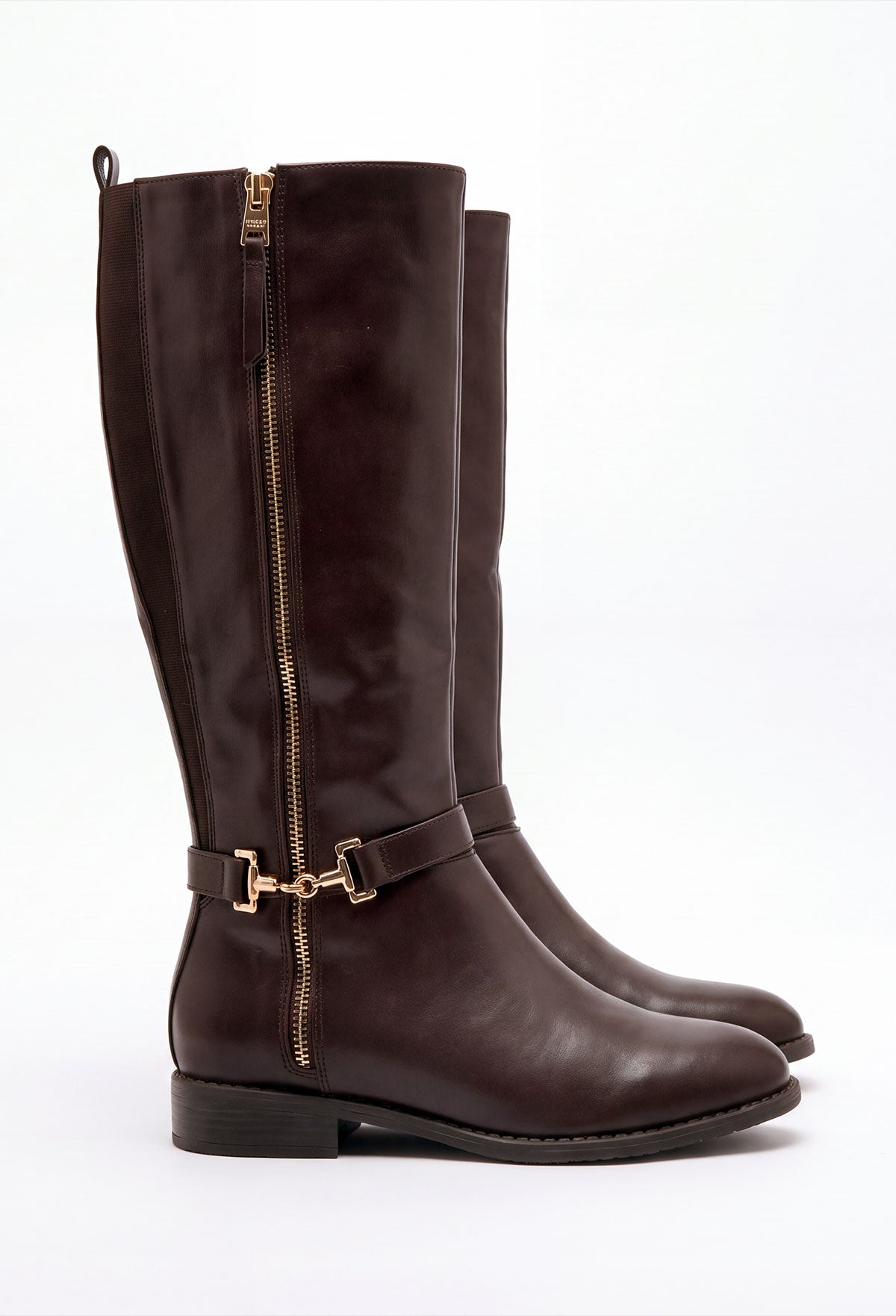 Brown faux leather riding boot with gold trim, side zip fastening and gold hardware detail at the ankle.