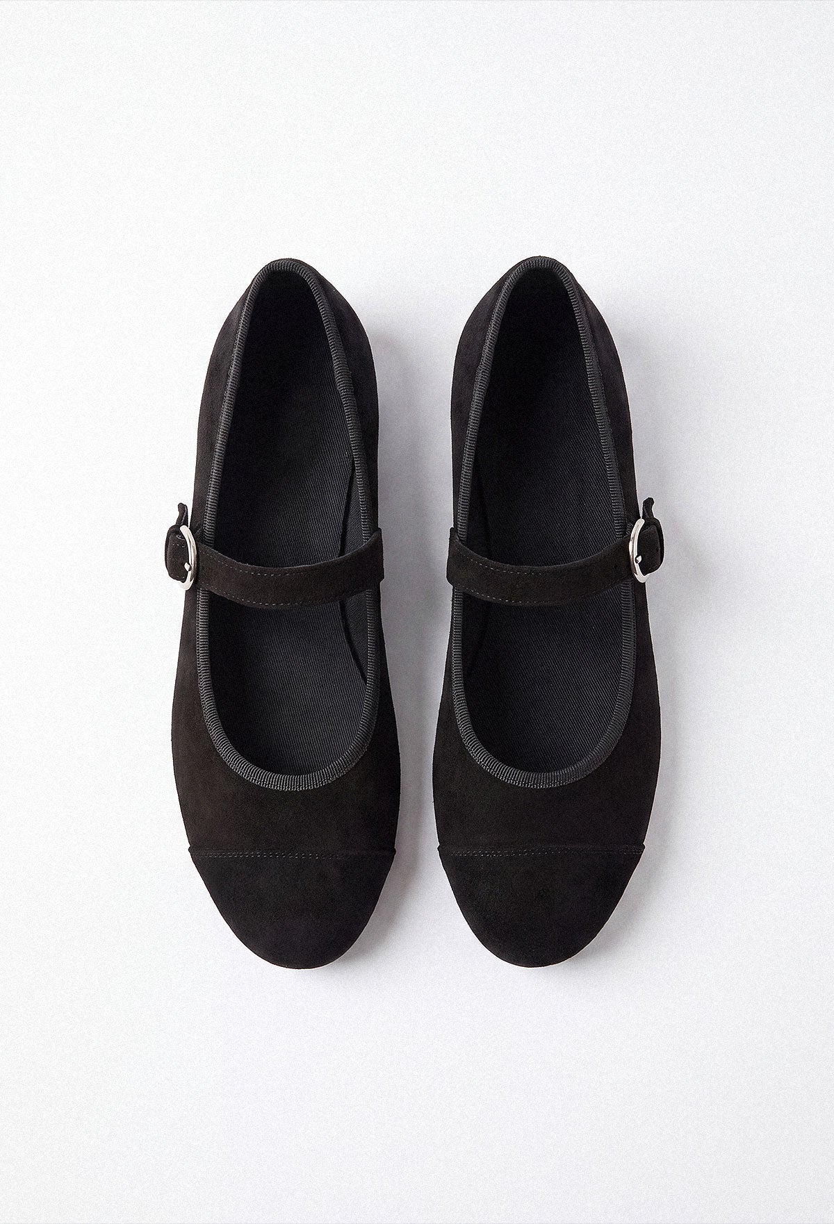 Black Mary Jane flat shoe in smooth matte black with a rounded toe and single strap fastening.