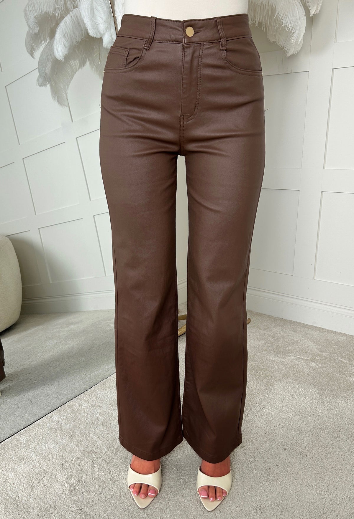Brown faux leather stretch wide leg jean with high waist, belt loops and a smooth, glossy finish.