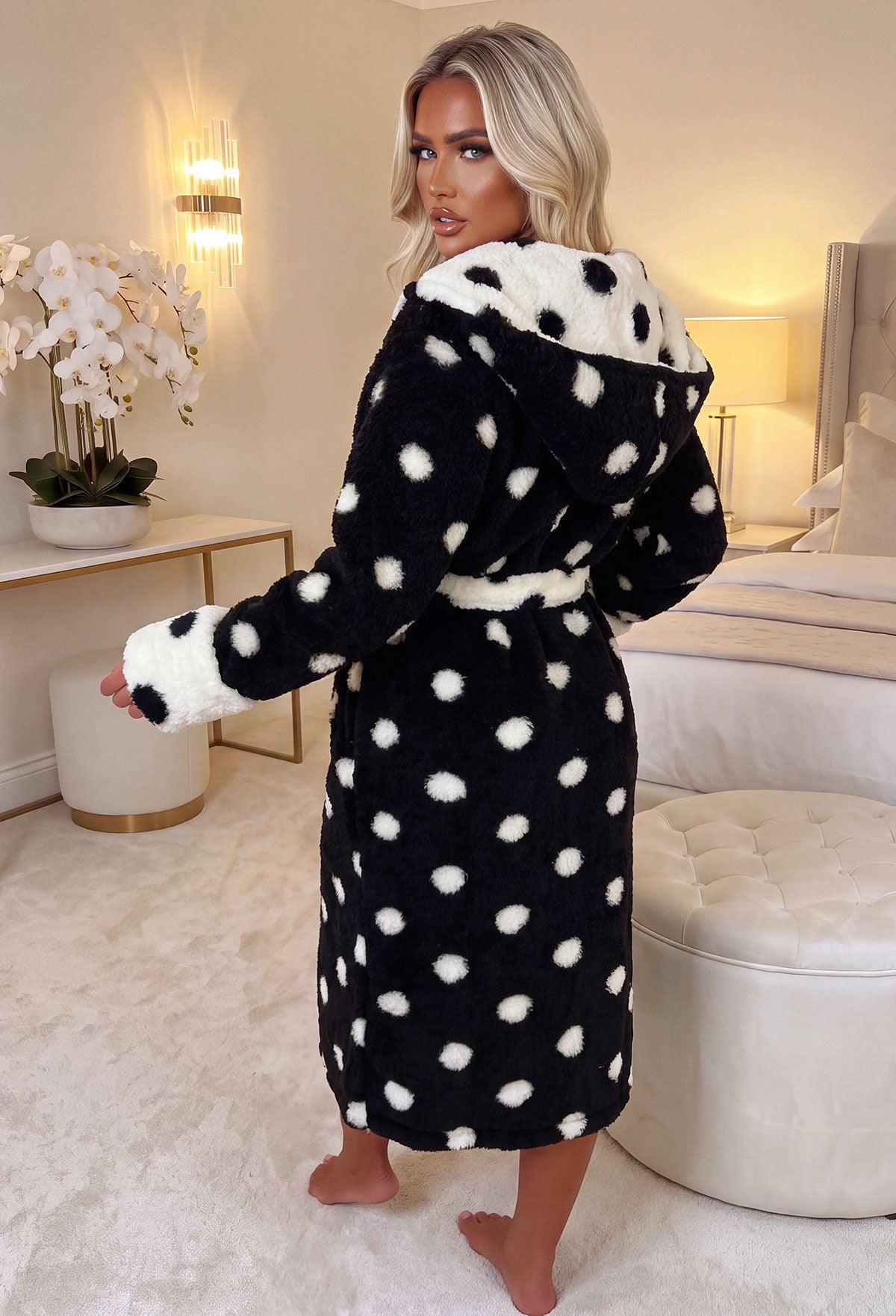 Black polka dot dressing gown with a fluffy texture, shawl collar, tie waist and contrast cuffs.