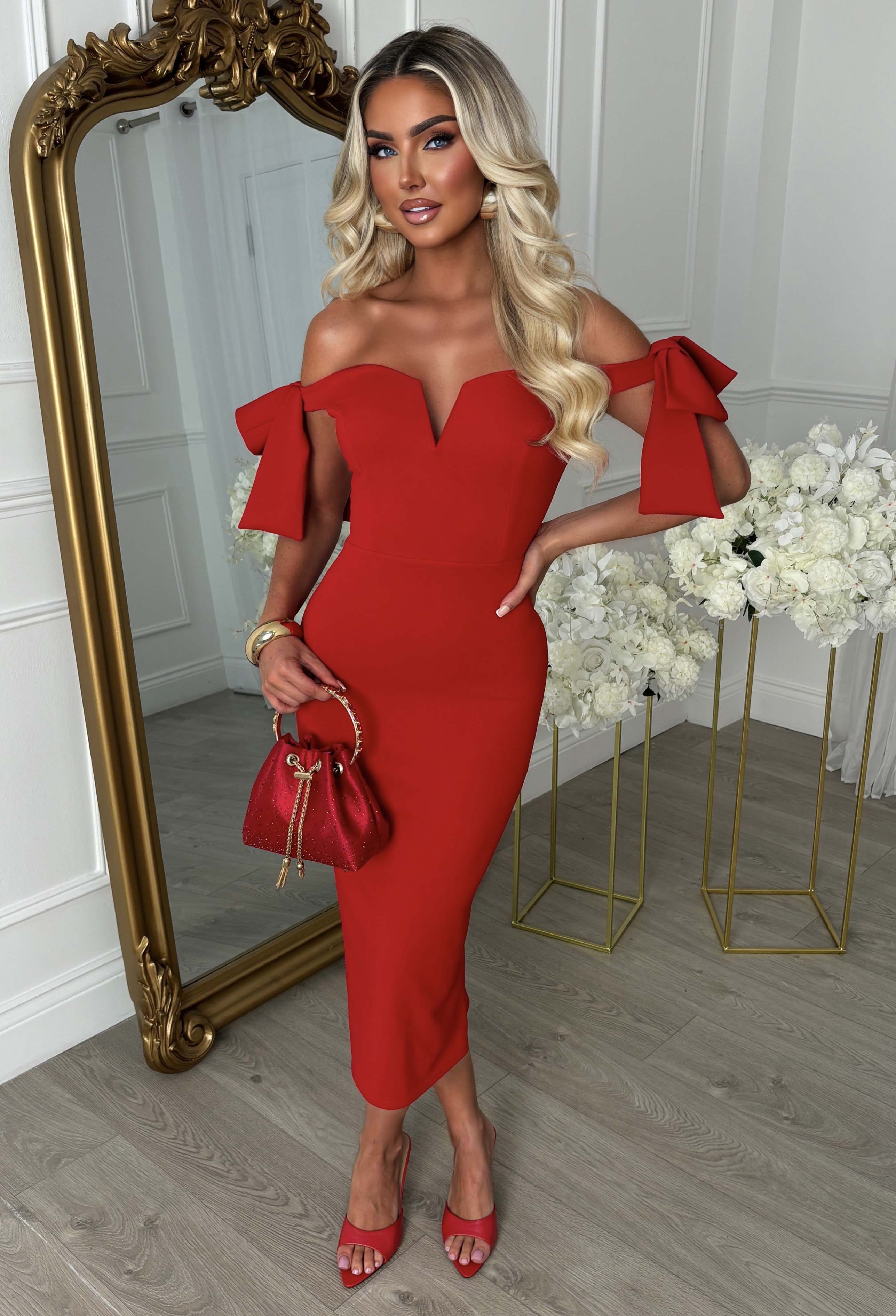 Red maxi dress with off-the-shoulder neckline, fitted silhouette and statement side bow detail.
